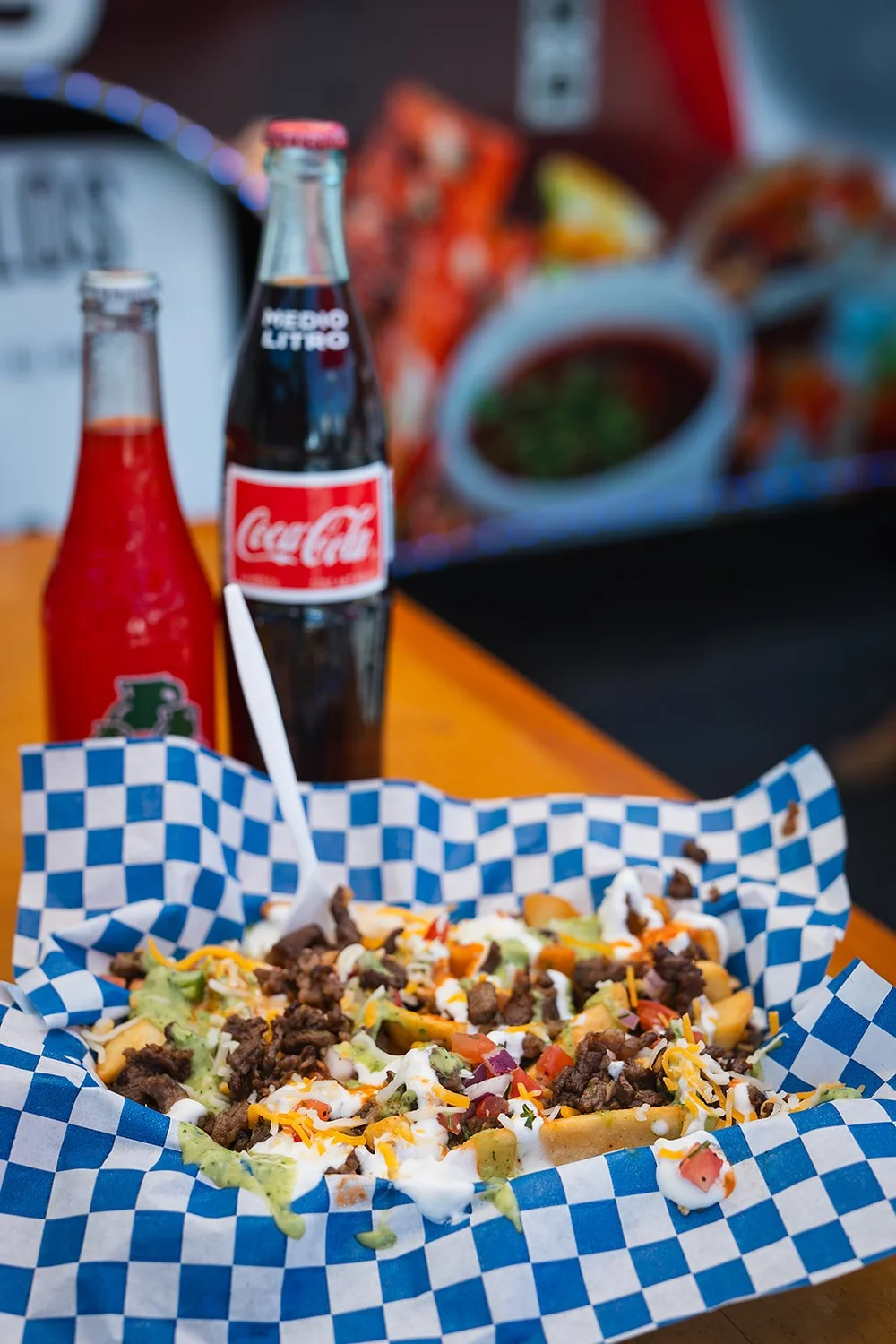 A basket of tacos with Mexican Coca-Cola bottles