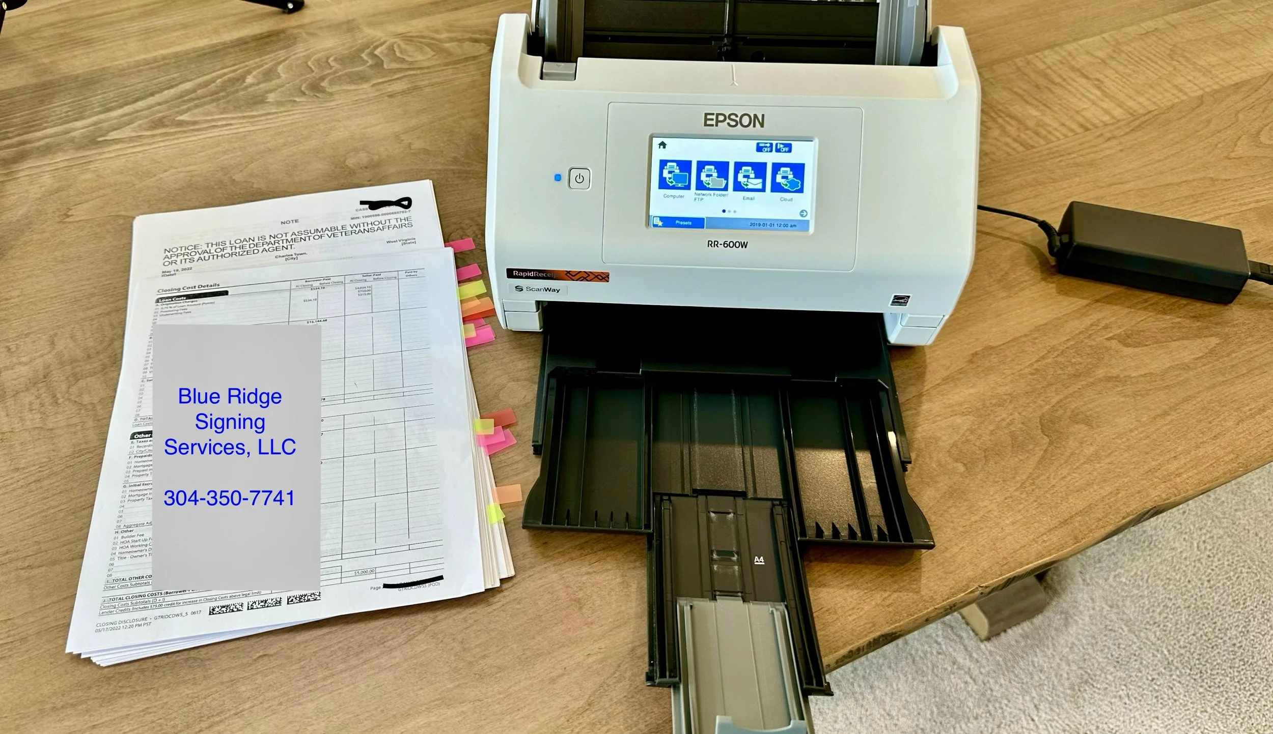 Completed loan package with Epson scanner ready for scan-back