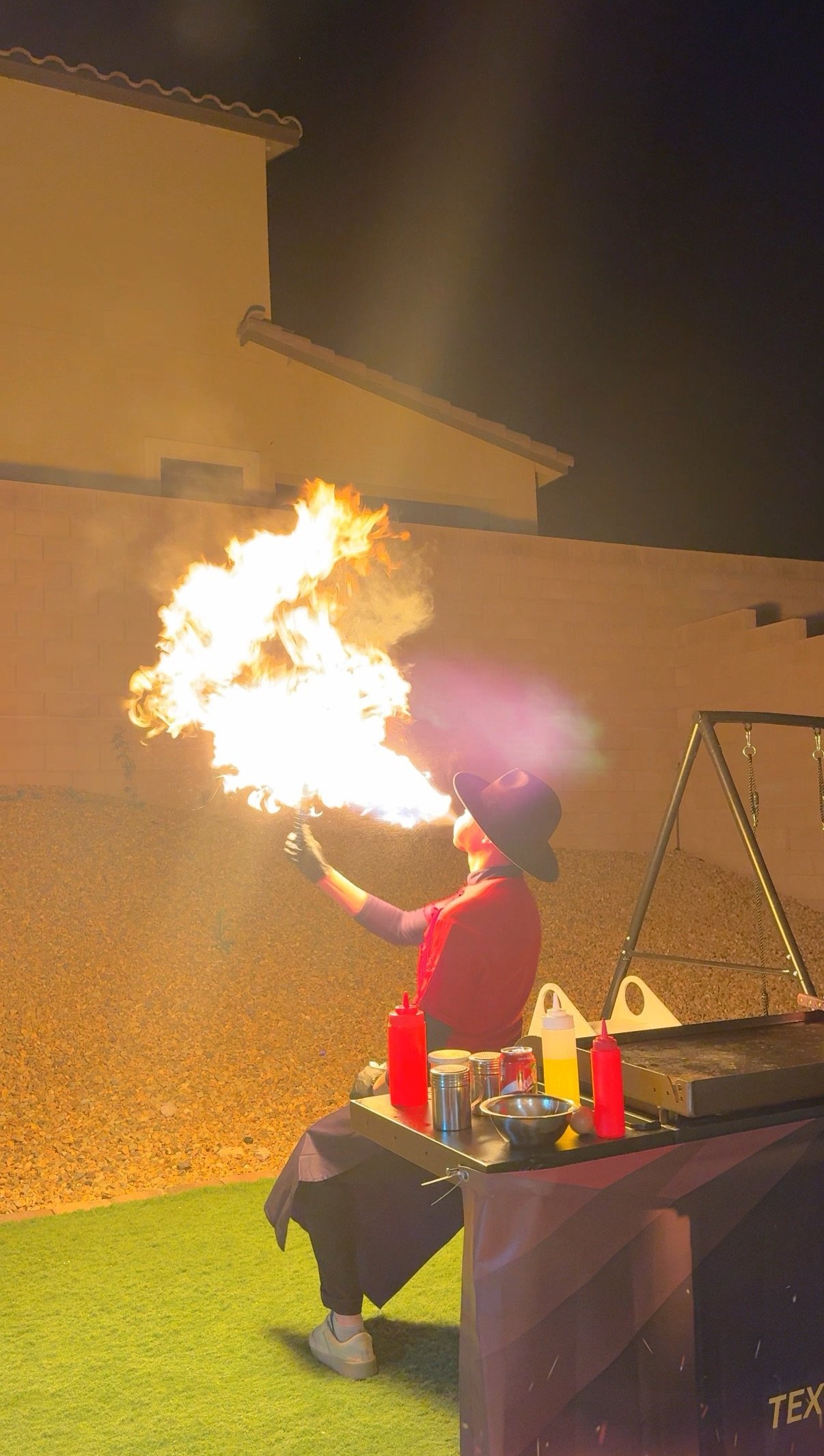 Hibachi chef performing a live fire show trick