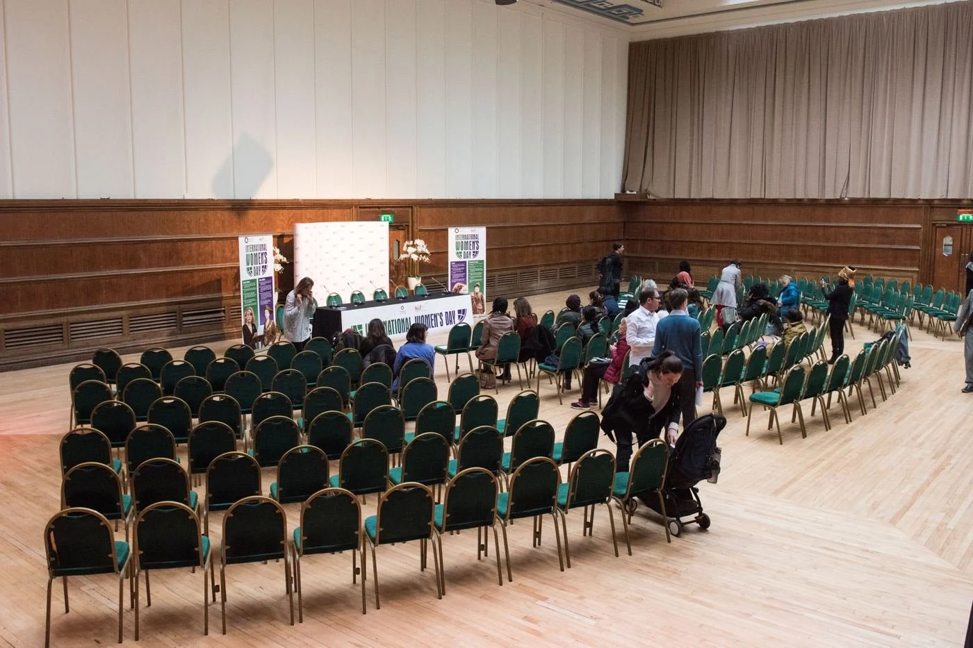 Guests arriving and taking seats in a large hall