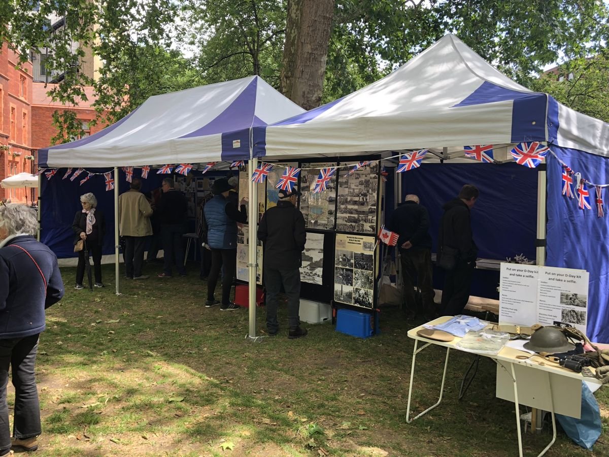 Visitors reading history boards in marquees hung with Union flag bunting