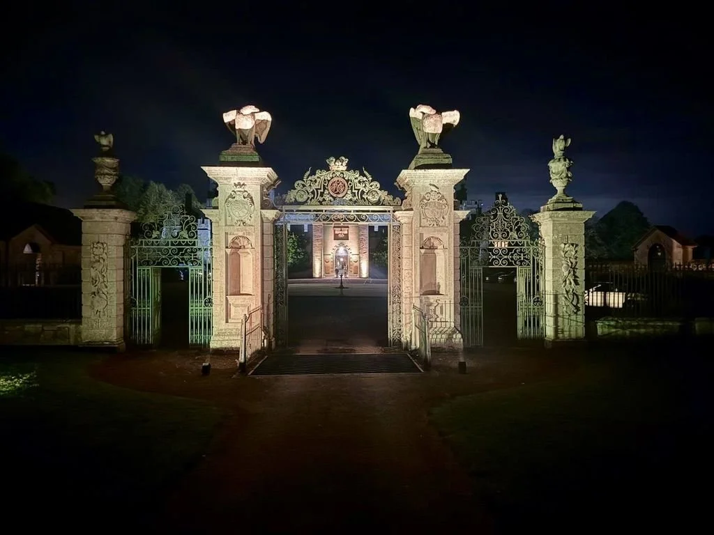 Ornate gates lit up at night