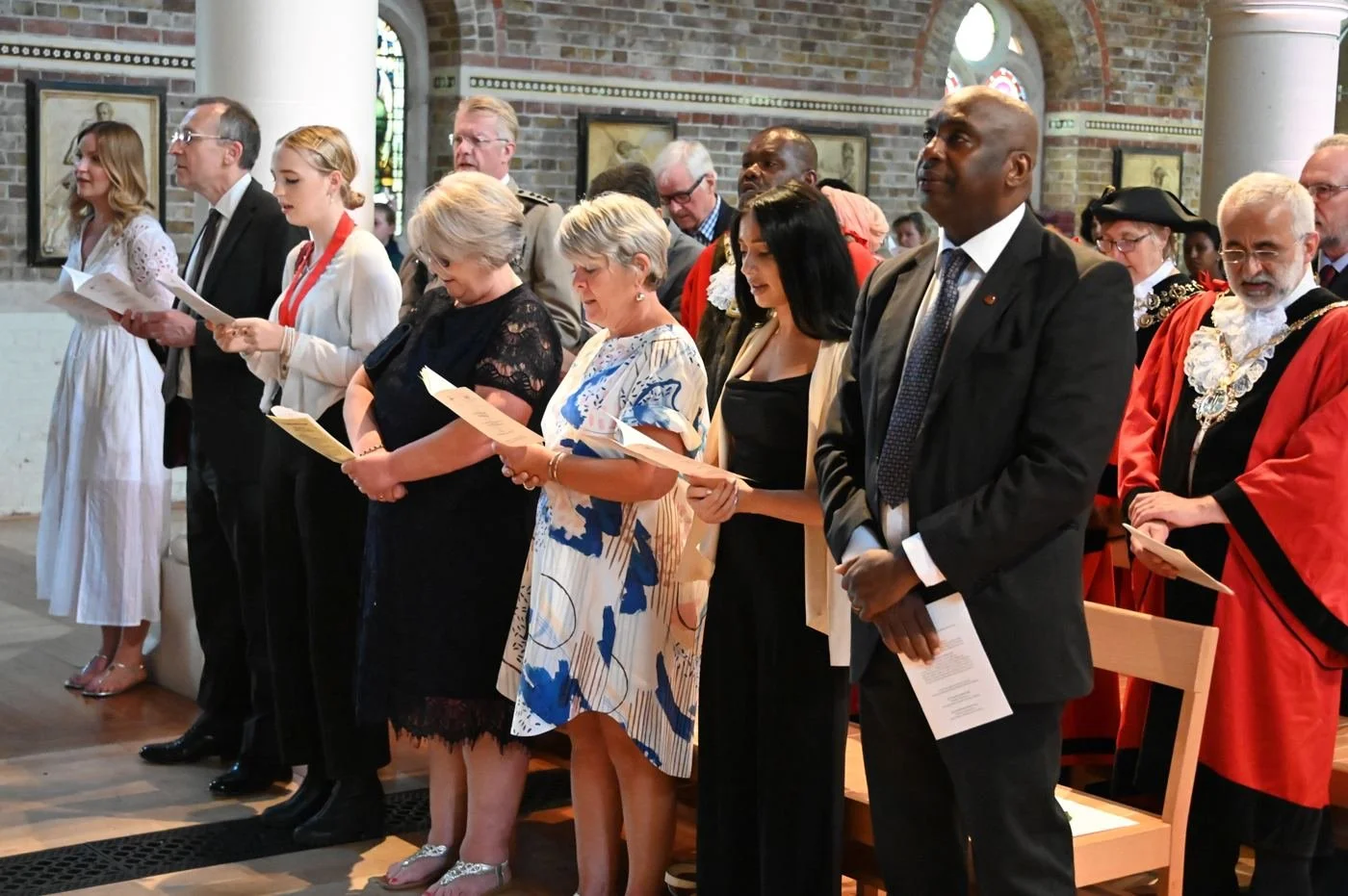 Mayors and guests singing at a civic church service