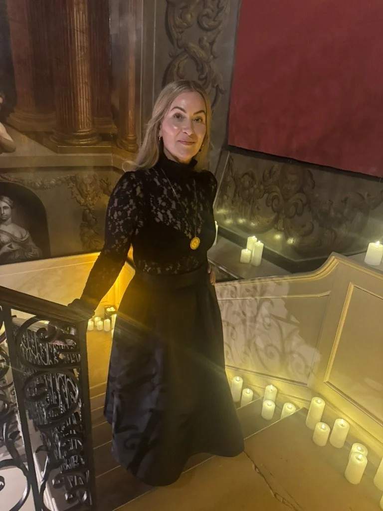 Layla on the candlelit painted staircase at Drayton House