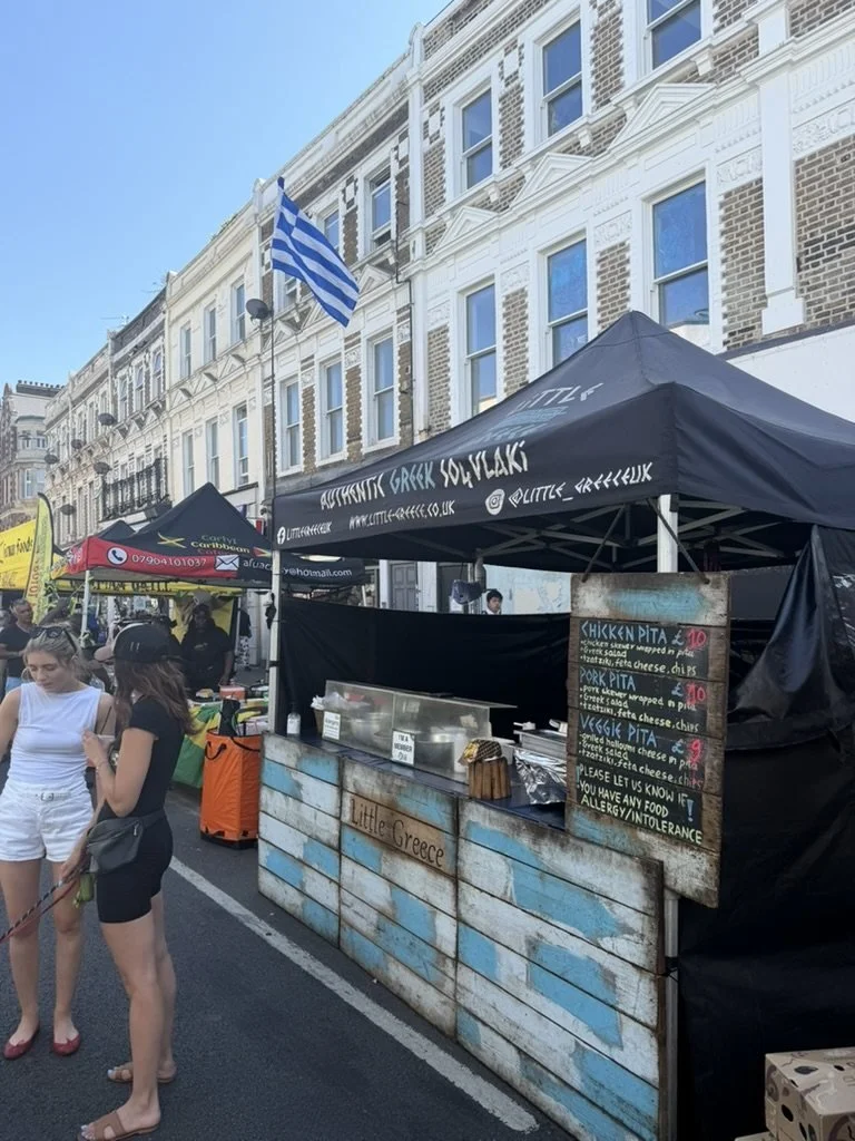 A Greek souvlaki stall beneath the Greek flag
