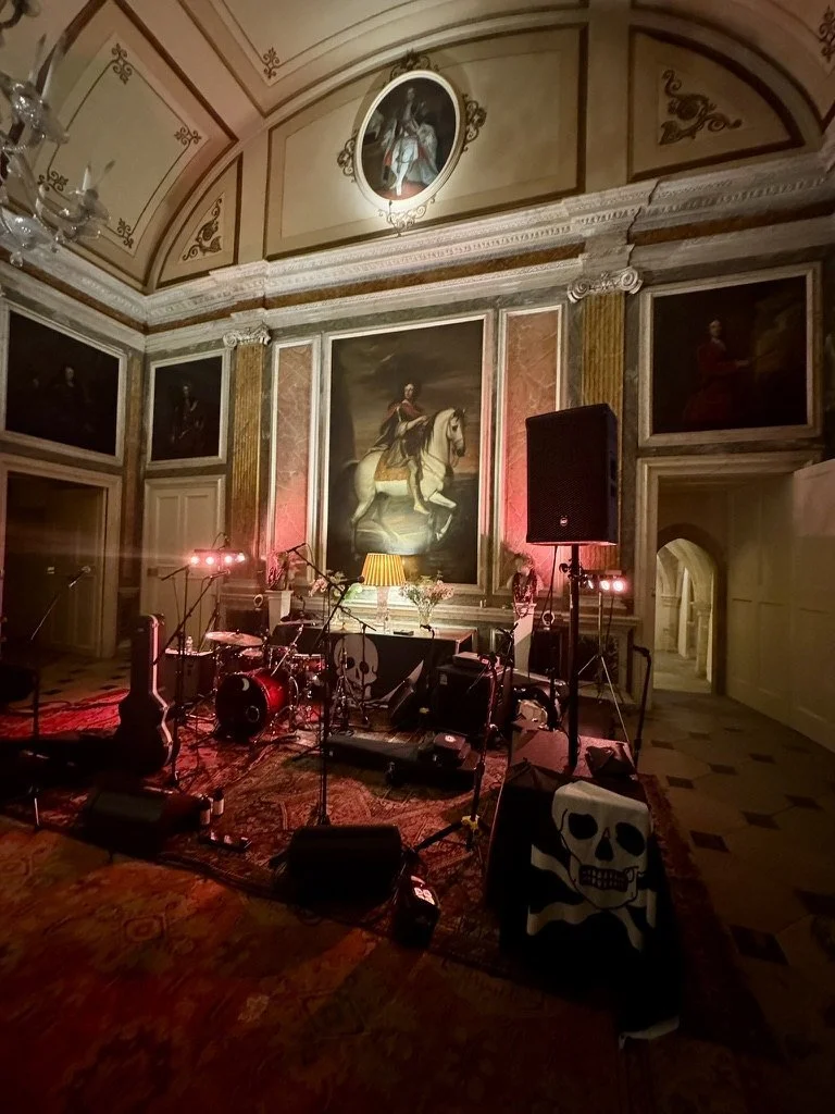 A band set up to play beneath the portraits in a painted state room