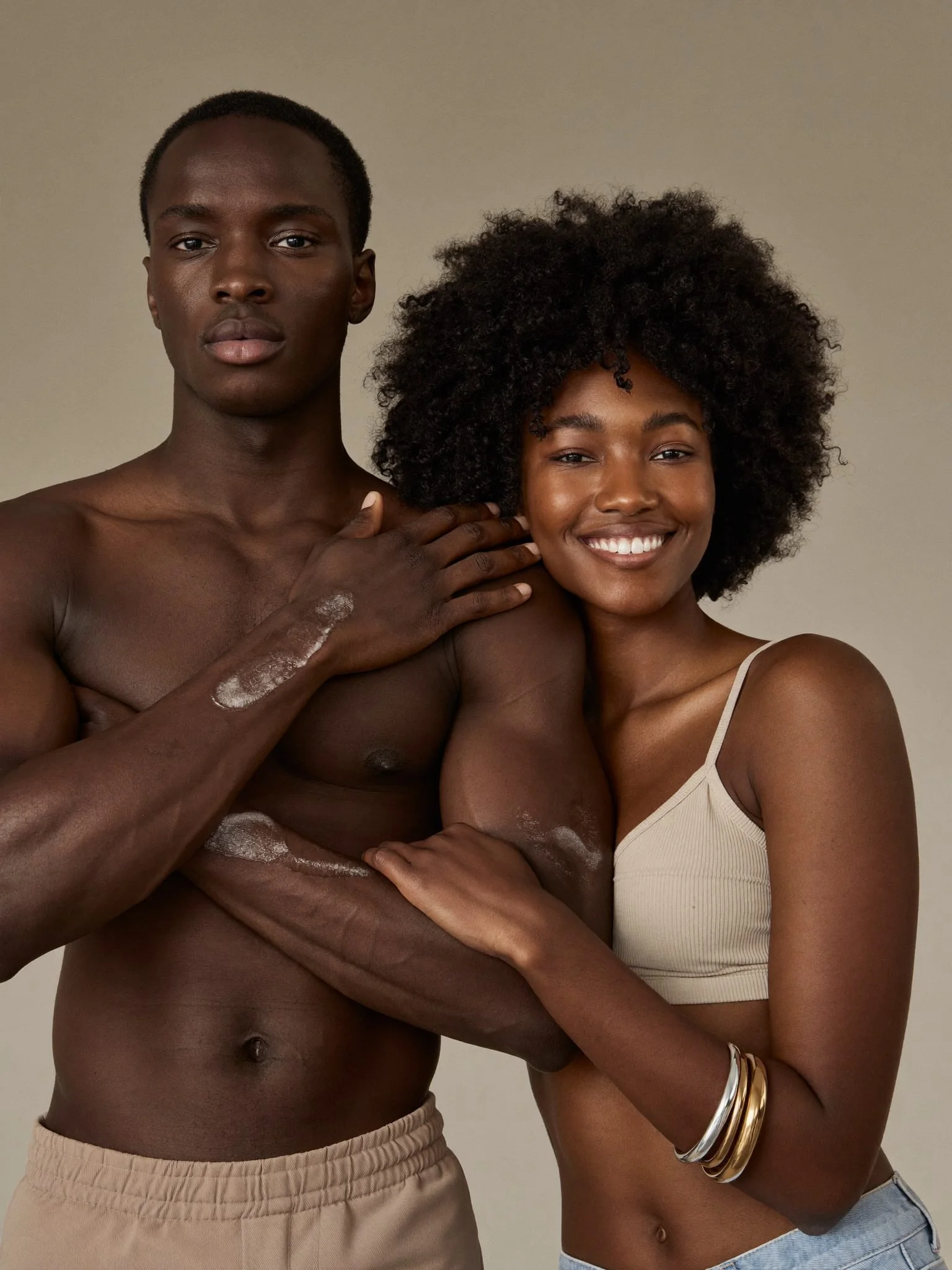 A Black man and woman moisturizing together