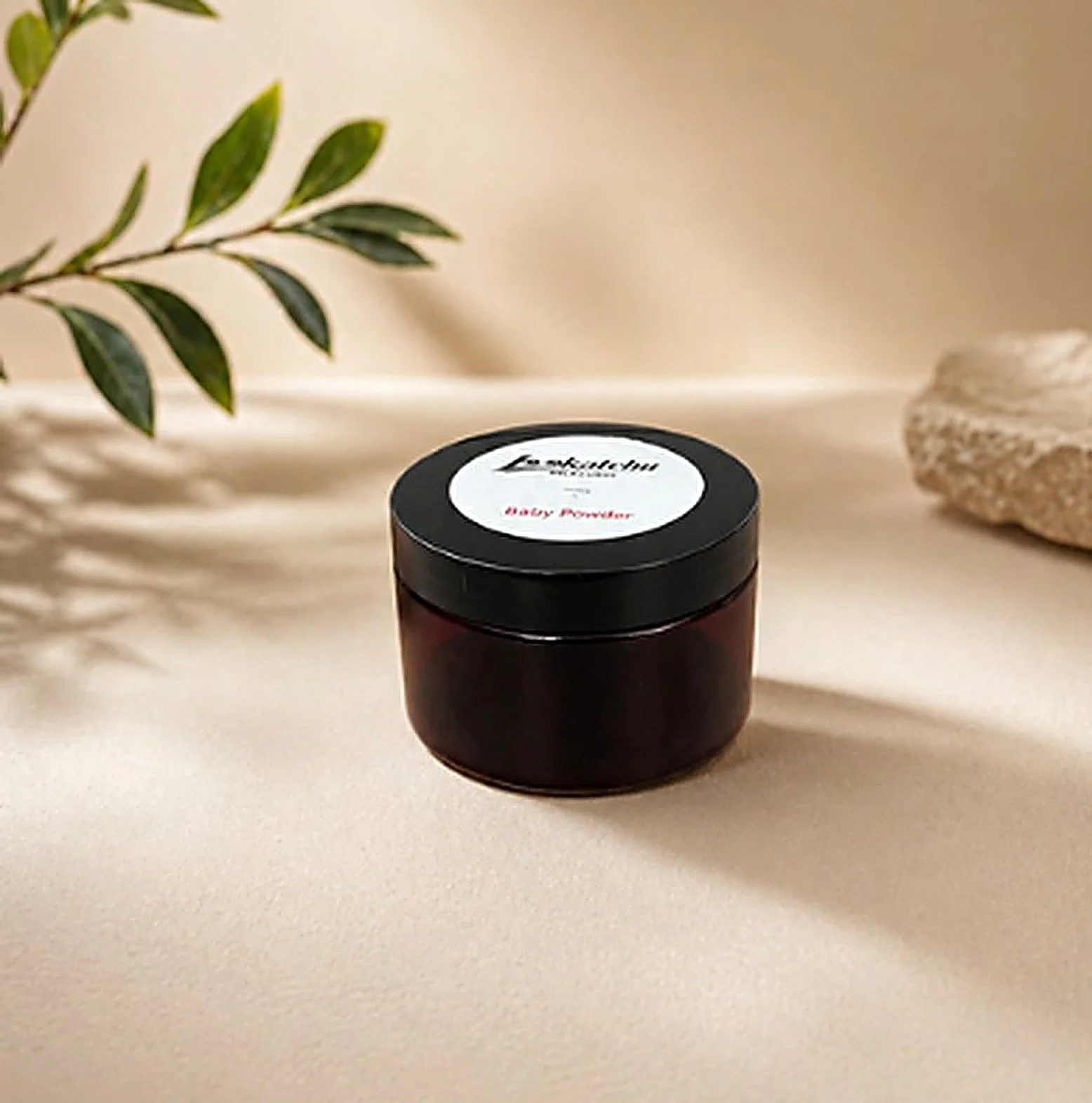 Mega size body butter in an amber jar with a leaf and stone