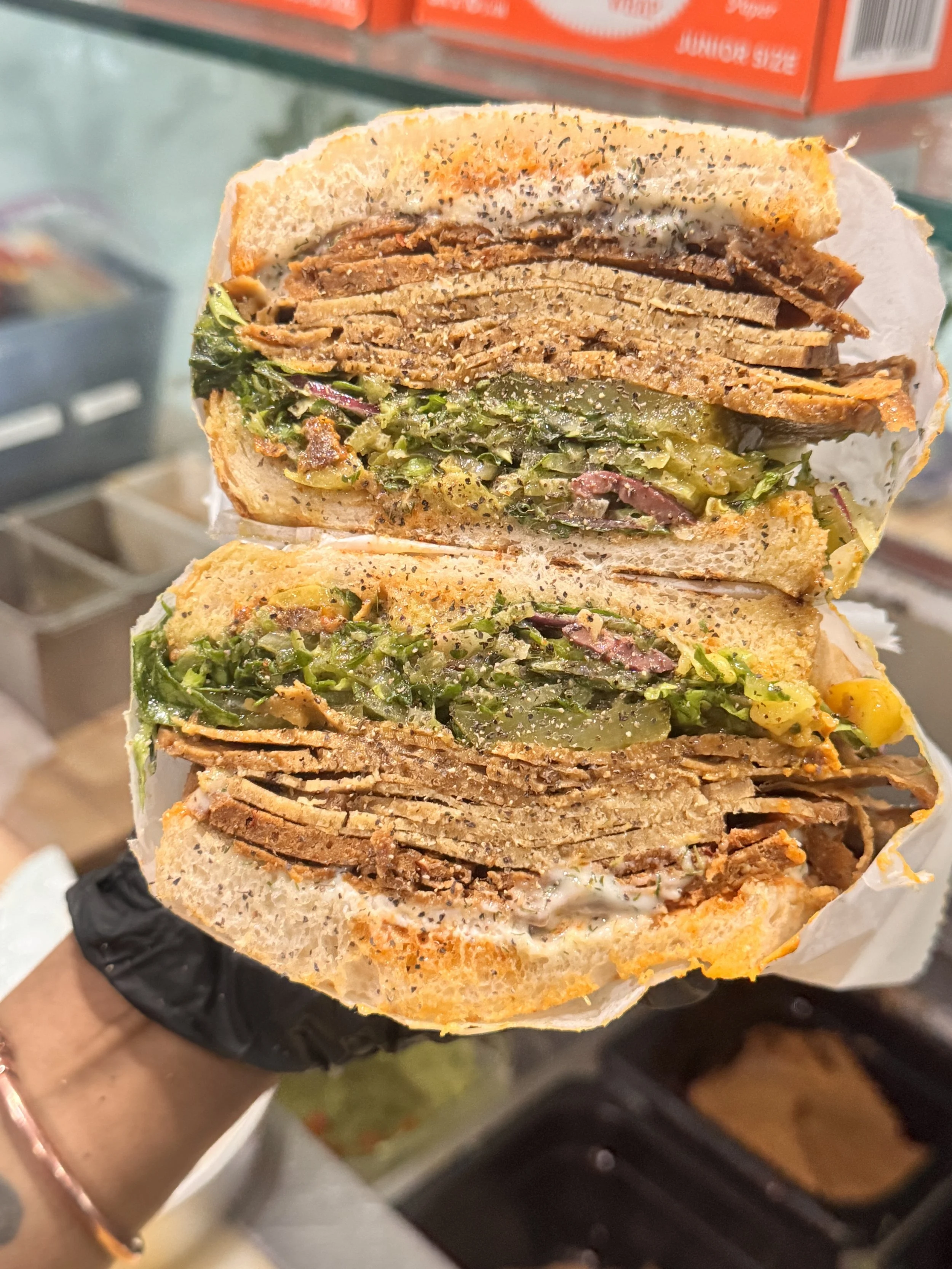 A stacked RHW sandwich with house-made deli slices and fresh vegetables