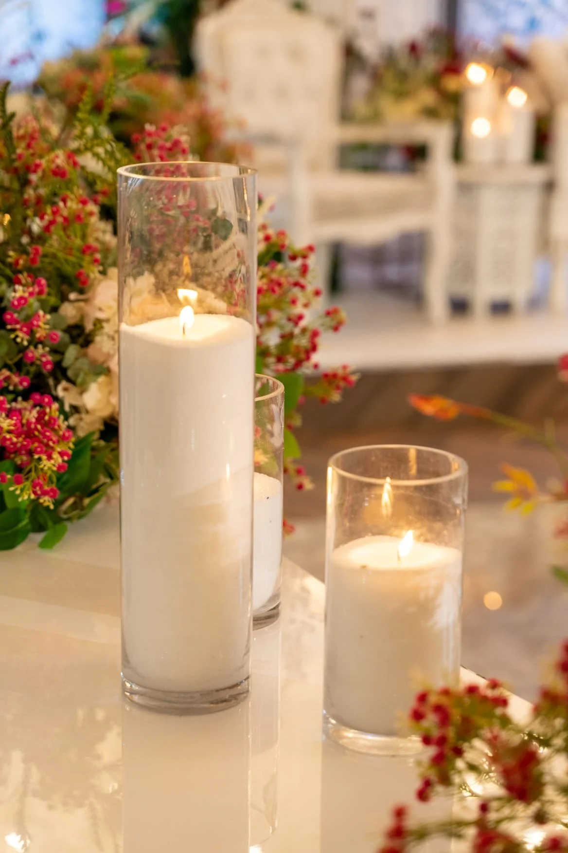 Candles and flowers beside the wedding stage