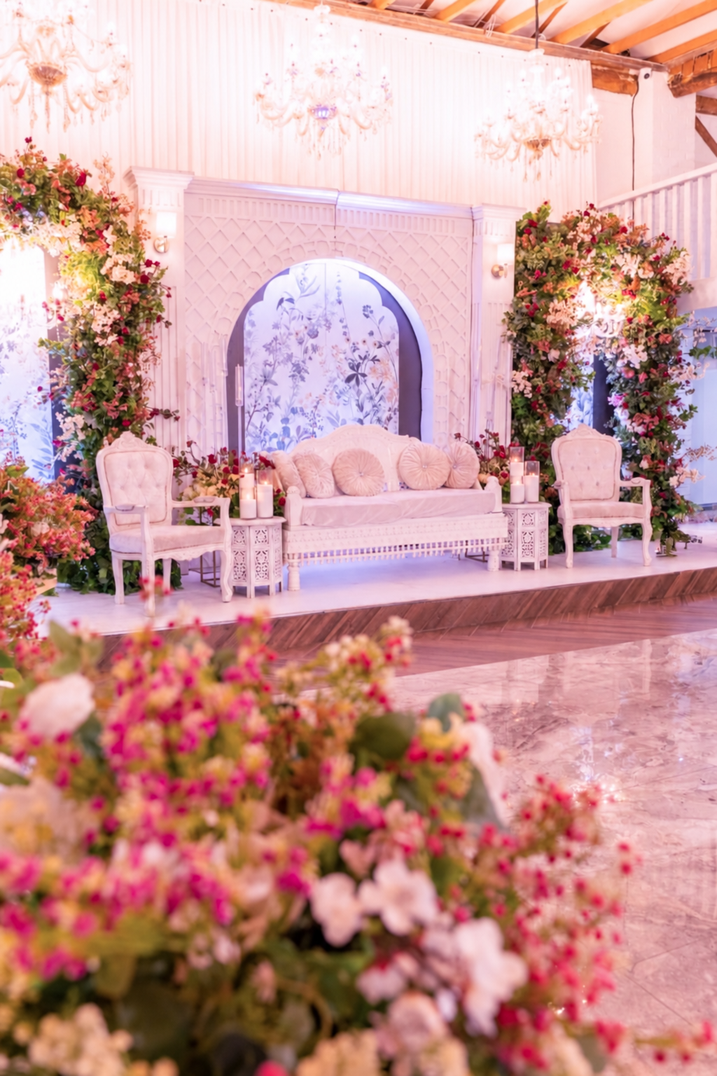 Ivory wedding stage with pink floral columns