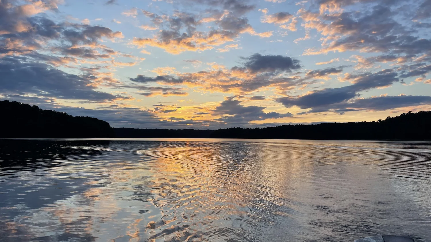 Rachel Stepek reference photograph of peach evening clouds reflected across open lake water