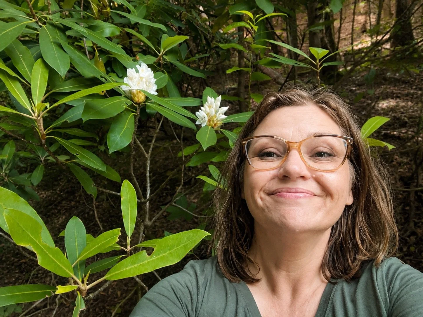 Rachel Stepek in rhododendron woods gathering native plant reference material