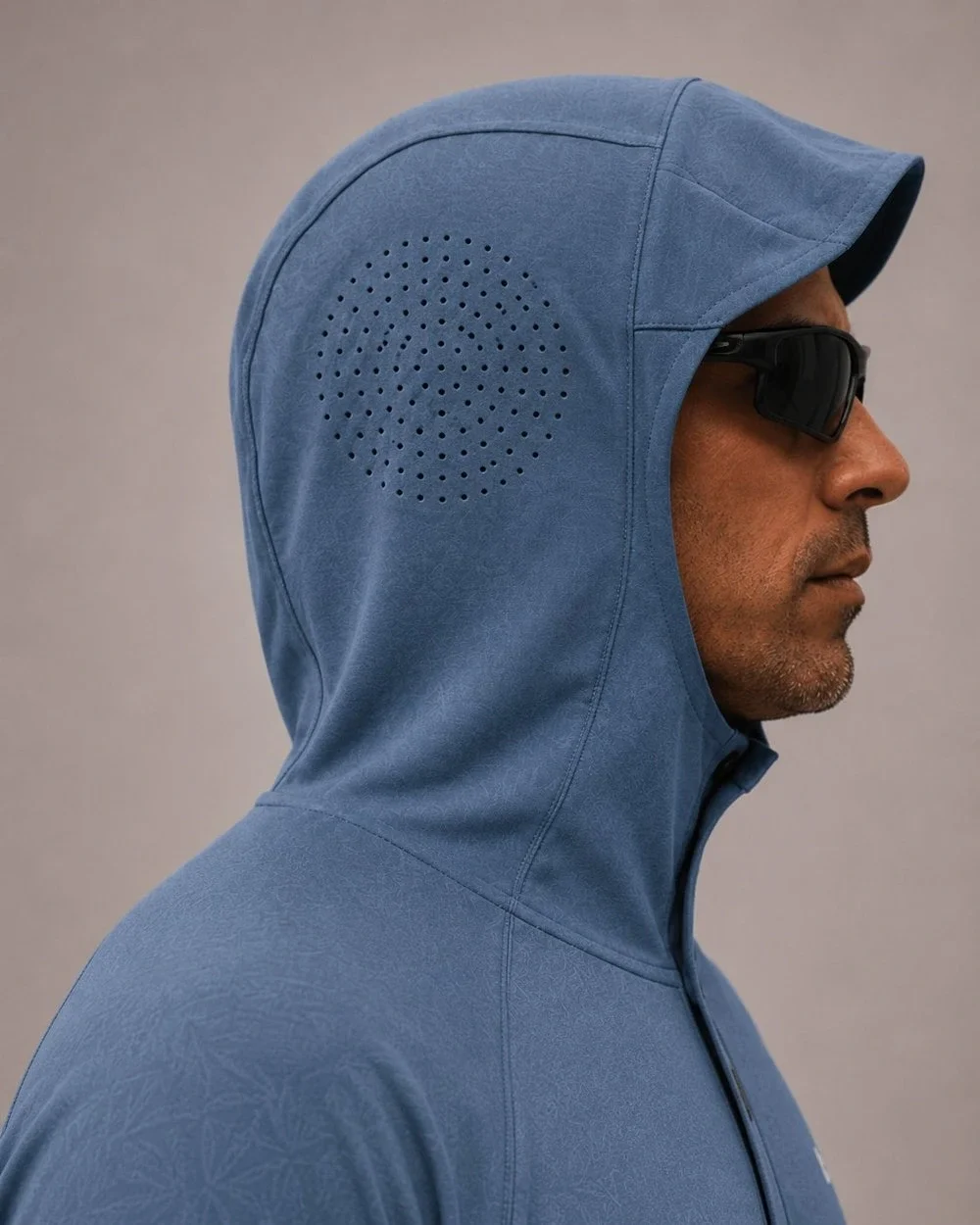 ARKE Sun Hoody hood up in profile, laser-cut perforation cluster seated over the ear