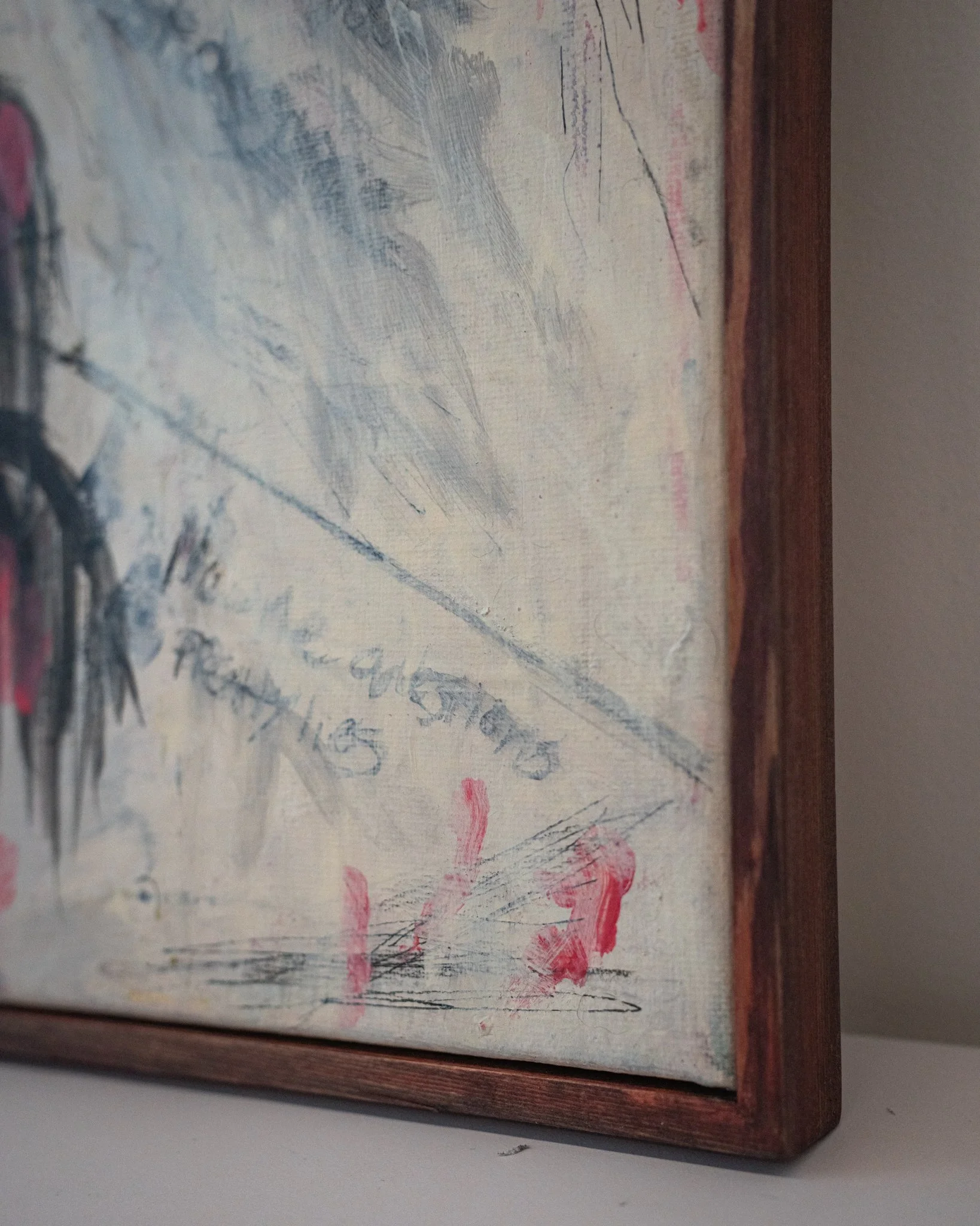 Blind Spots — bottom corner detail showing the second inscription scratched out in pencil