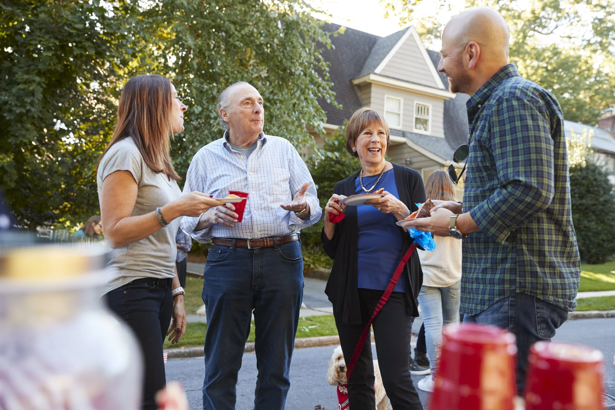 Adults enjoying food and drink at an outdoor gathering