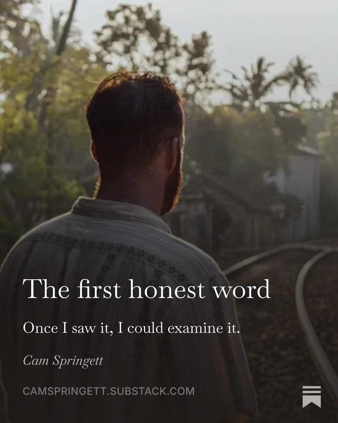 The first honest word. Once I saw it, I could examine it. Cam Springett seen from behind, looking along a railway track lined with palm trees.