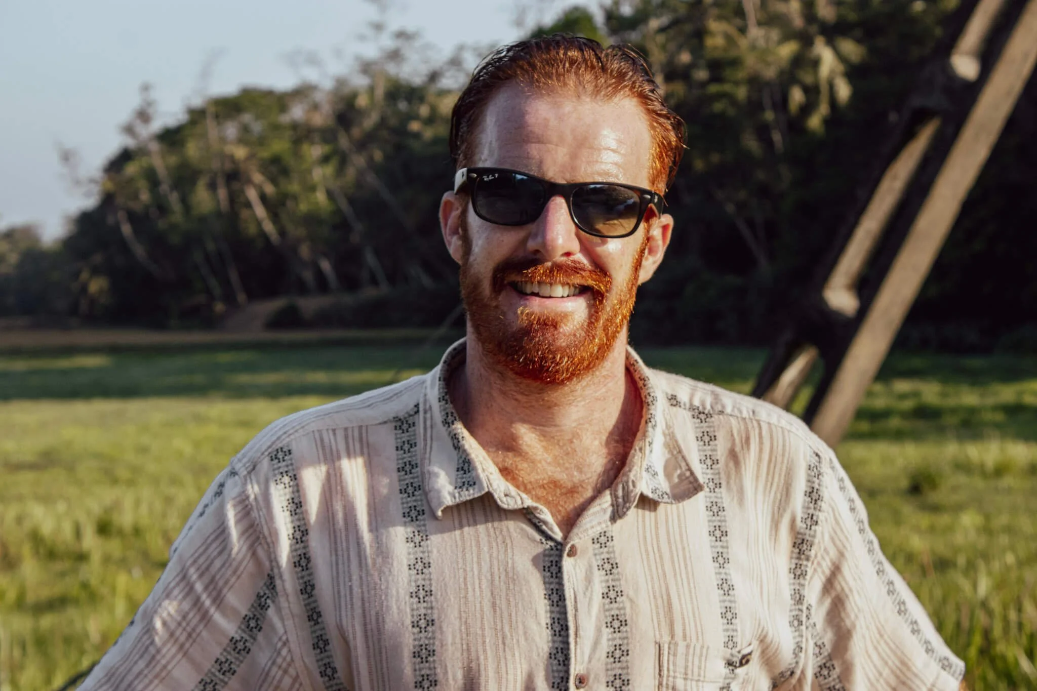 Cam Springett smiling in a paddy field in Sri Lanka