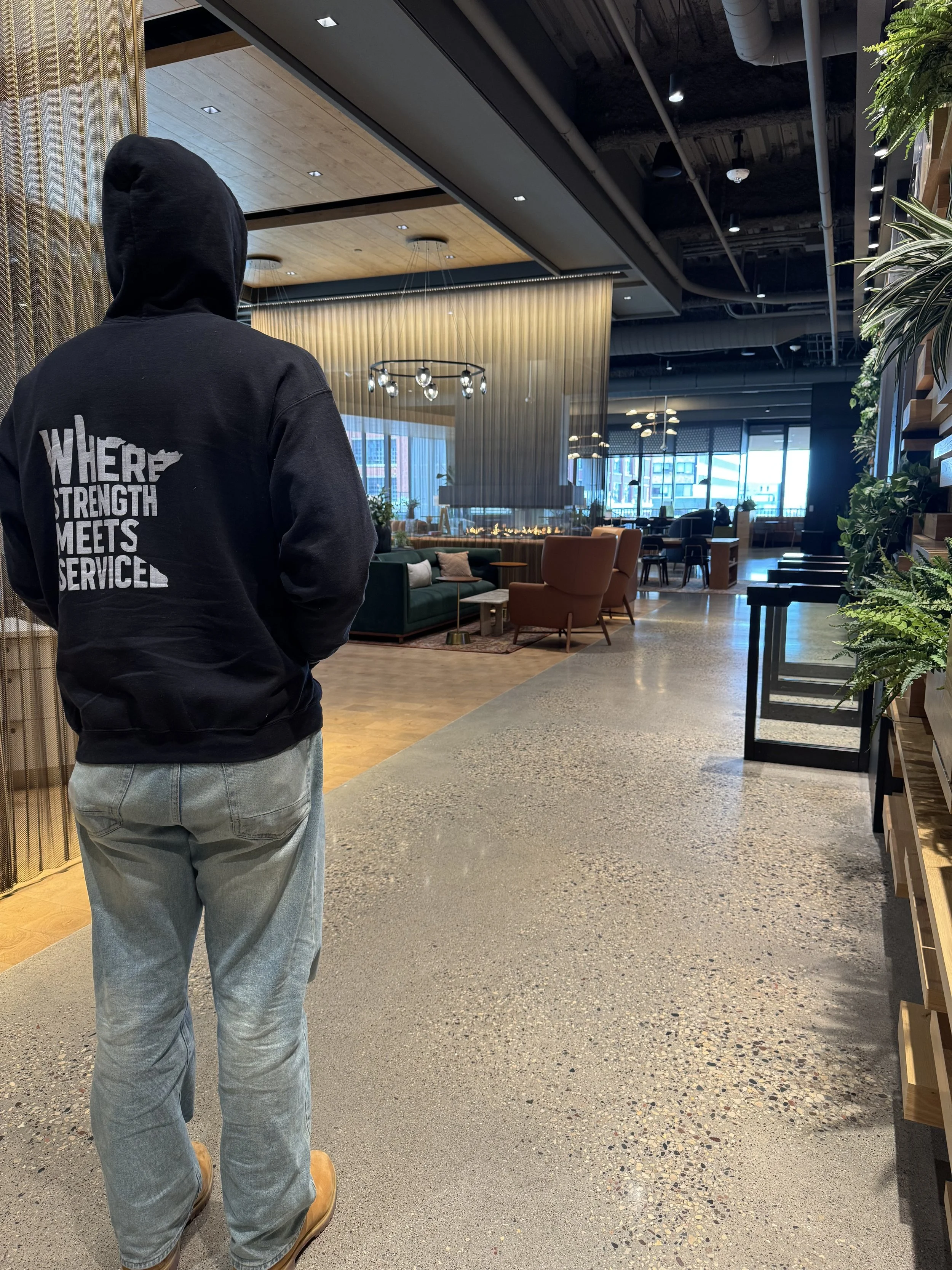 CPM crew carrying wrapped furniture through a home entrance