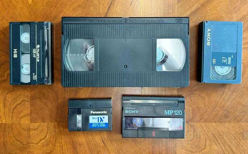 VHS, 8mm, and MiniDV tapes side by side