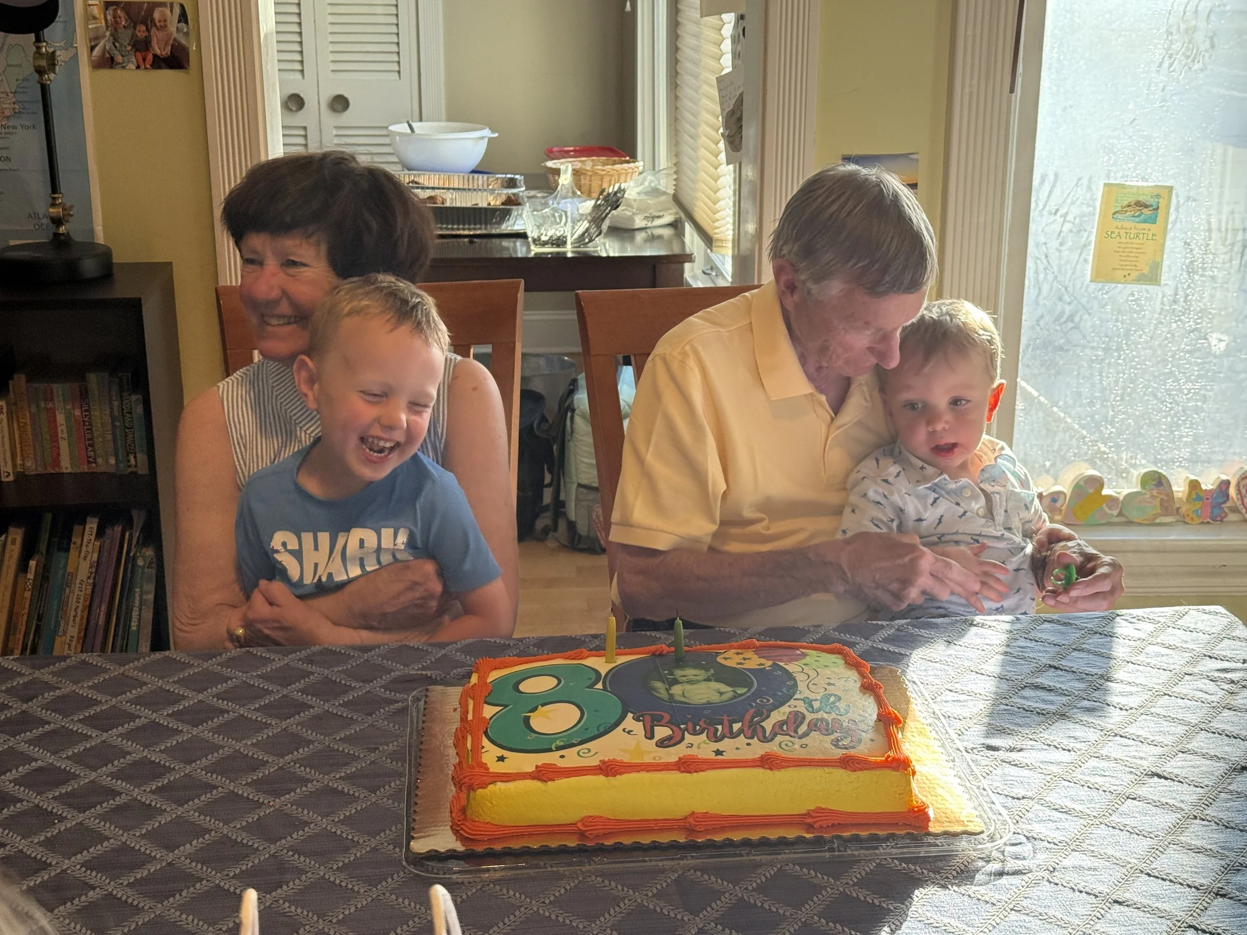 Pat, Dick, and grandsons on Dick's 80th birthday