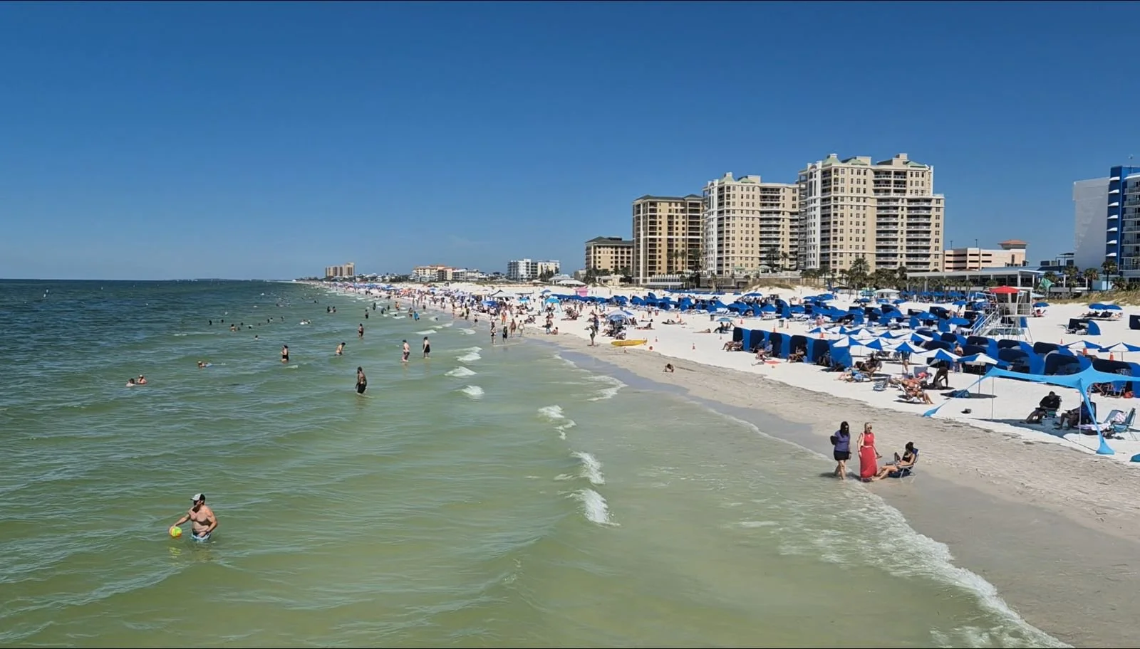 Clearwater Beach with white sand and blue cabanas, Travelling Pandas in Clearwater