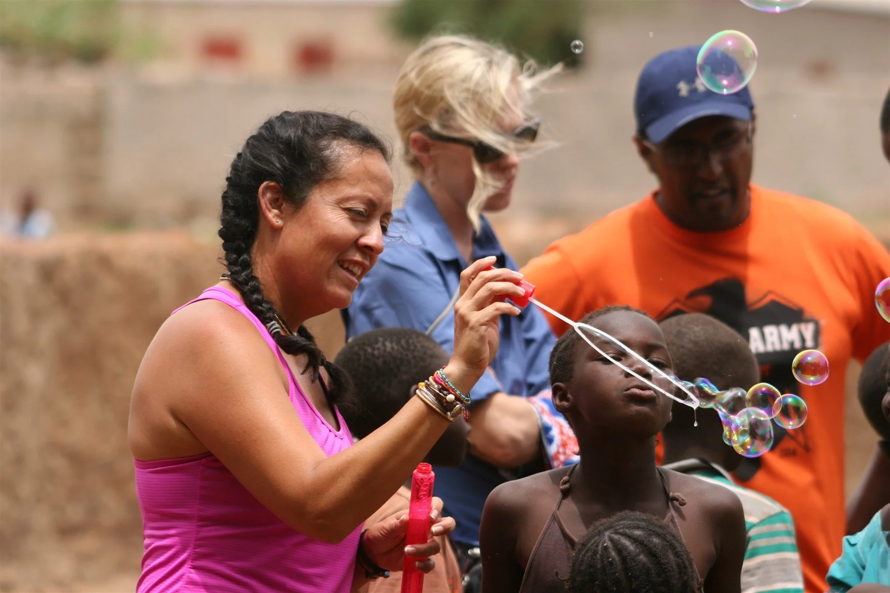Children and volunteers sharing a playful moment in Mali