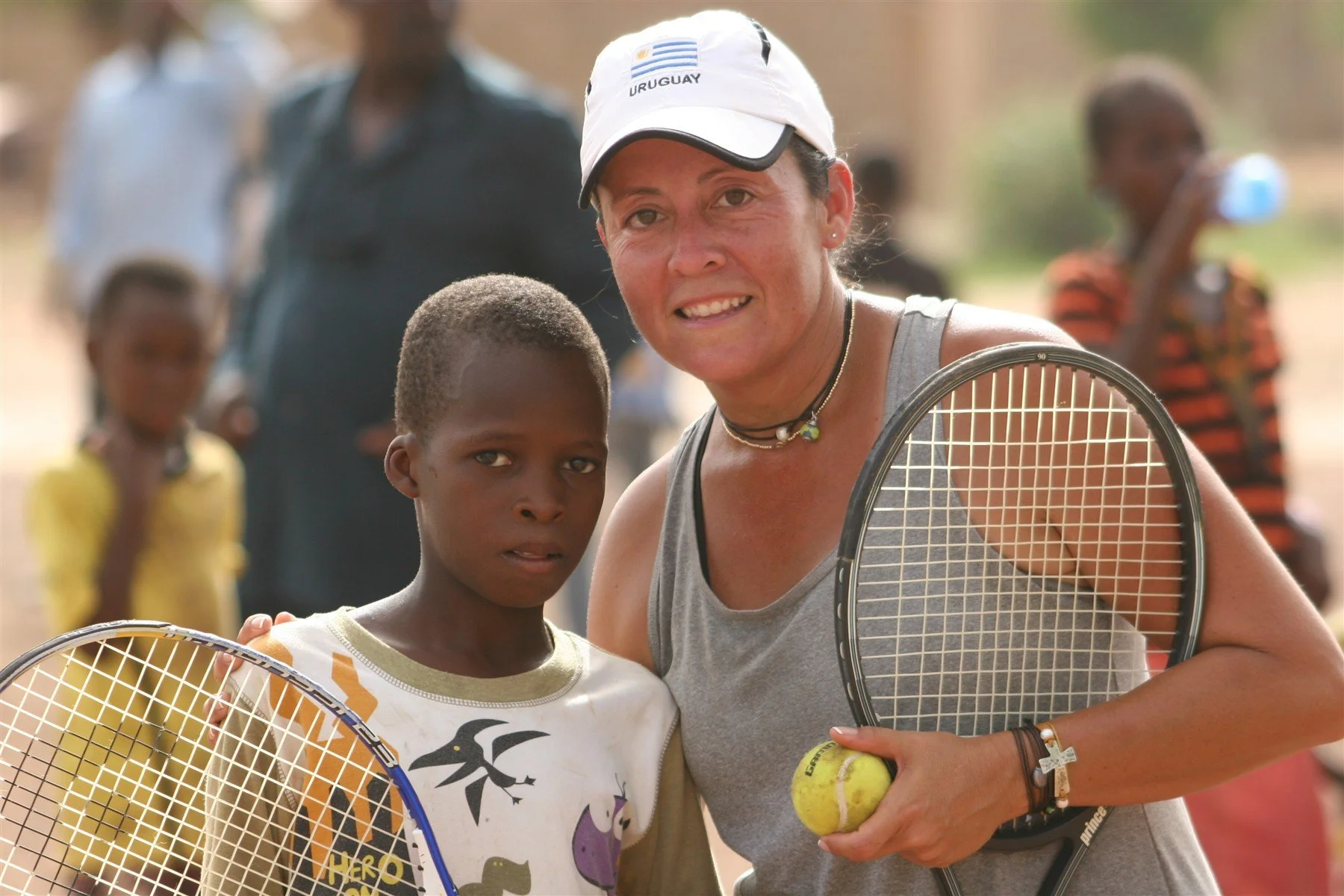 A tennis coach and young player together in Mali