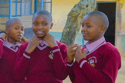 Kiteta Primary School graduates in the uniform of the national secondary school they earned a place at.