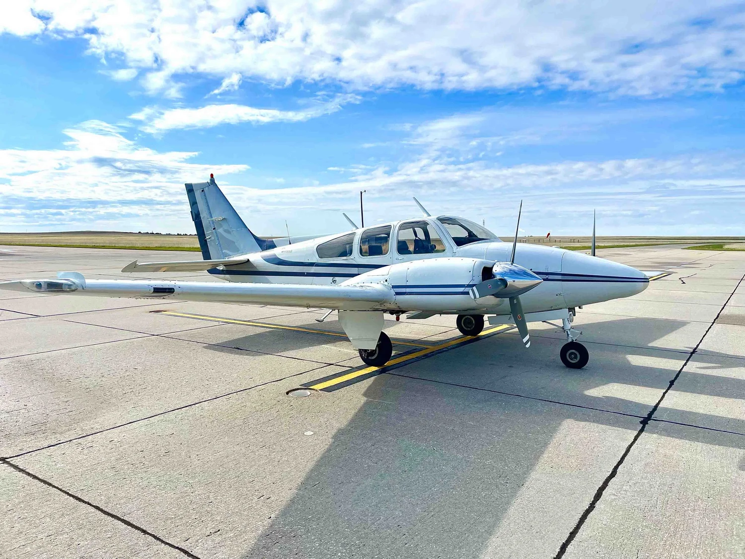 Colton Daum's Beechcraft Baron on the ramp under a Front Range sky