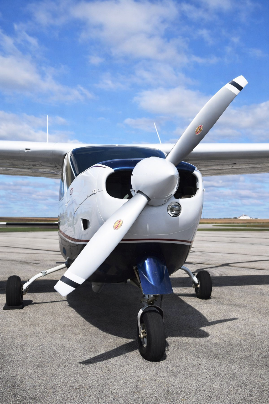 Single-engine aircraft on the ramp, propeller and nose up close