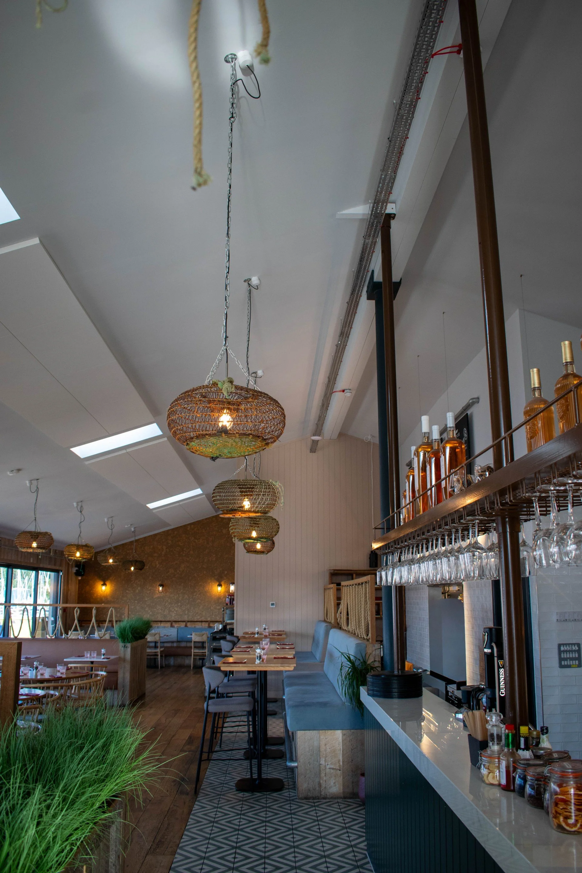 Salvis lighting design at Swanwick Boathouse, with woven pendant shades inspired by coastal fishing baskets