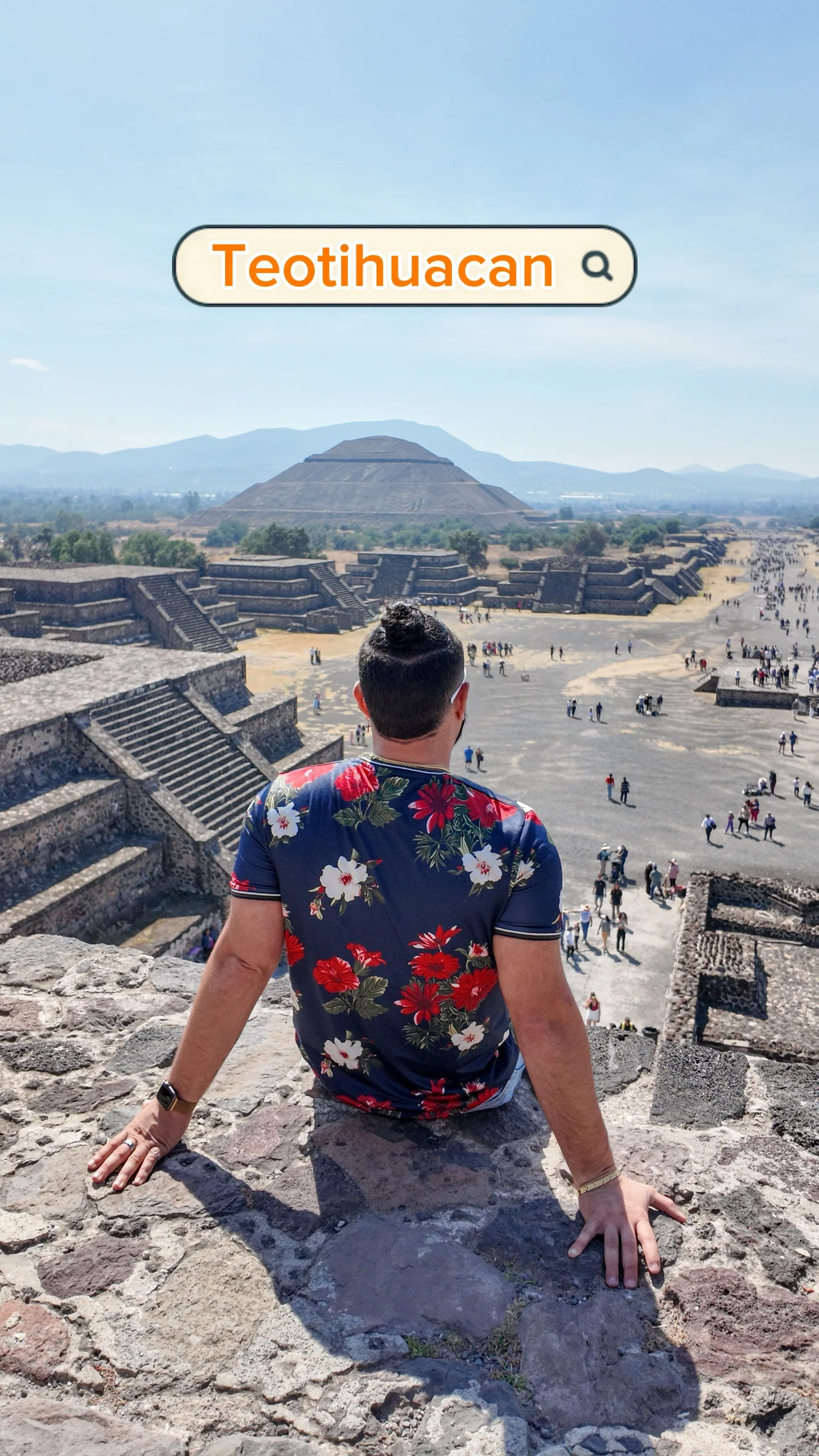 Jonny walking through the Teotihuacan pyramids in Mexico, backpack on, mid-stride