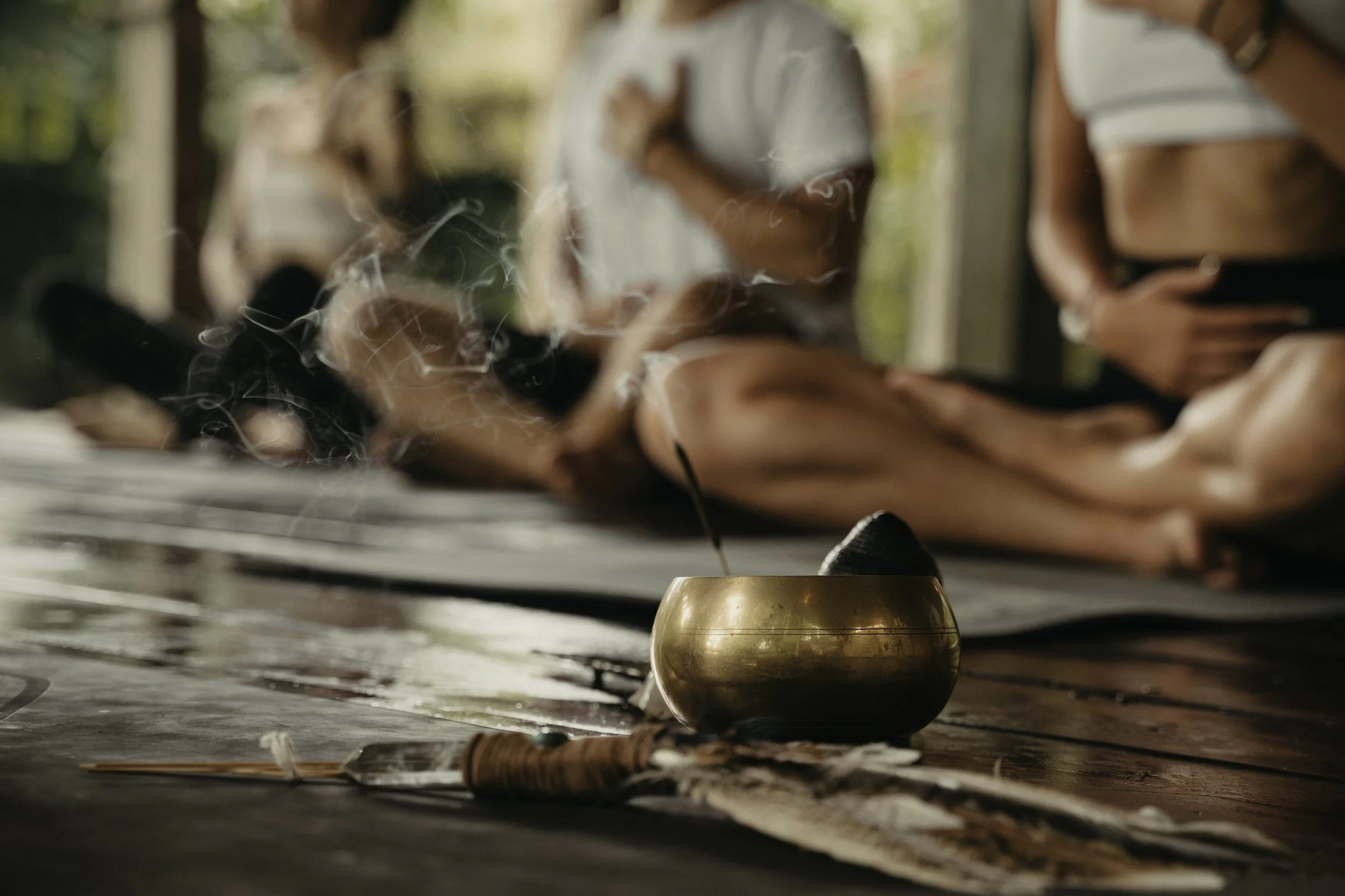 Tibetan singing bowl with incense smoke, group meditation session