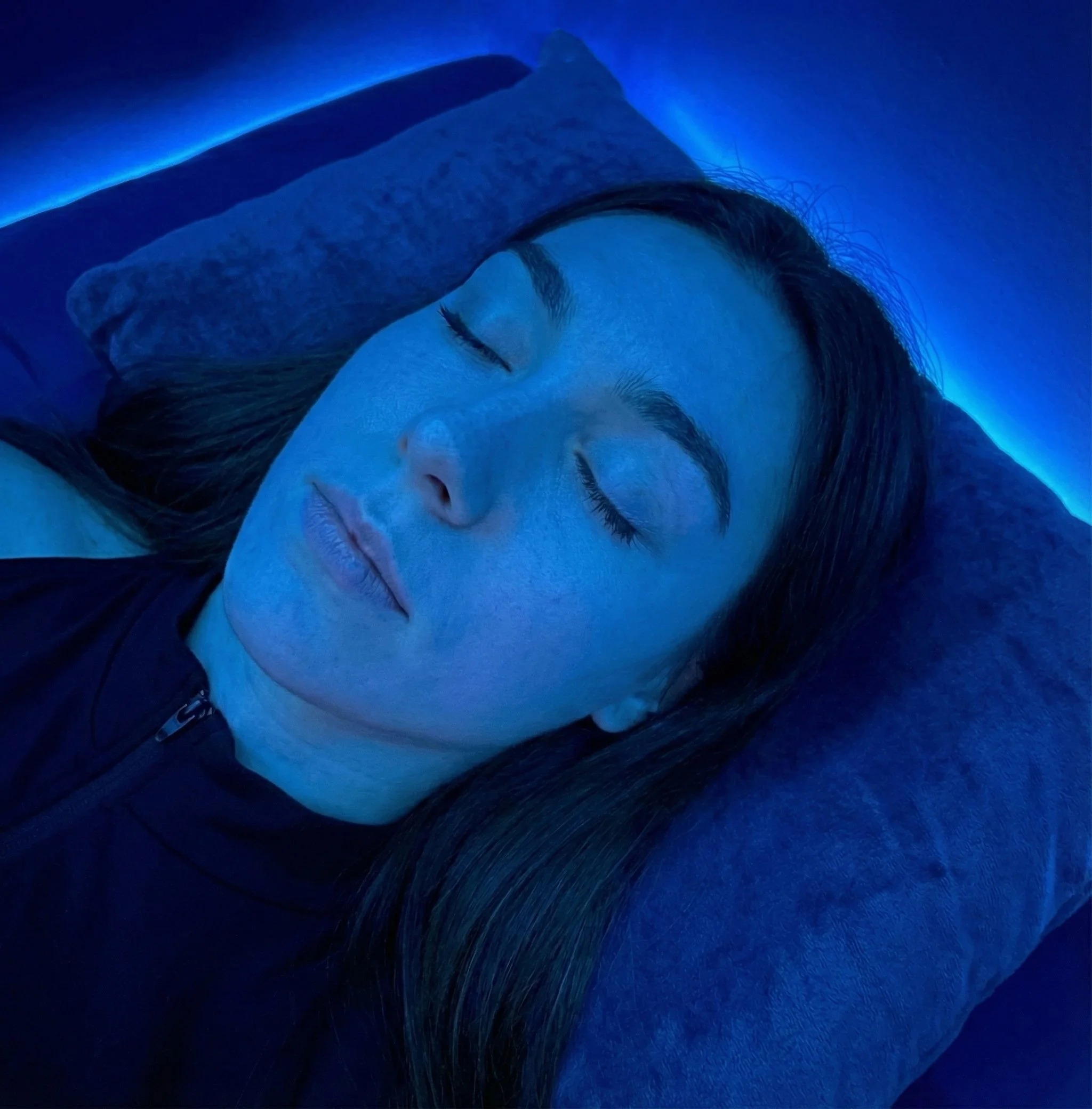 Woman receiving blue light therapy facial treatment