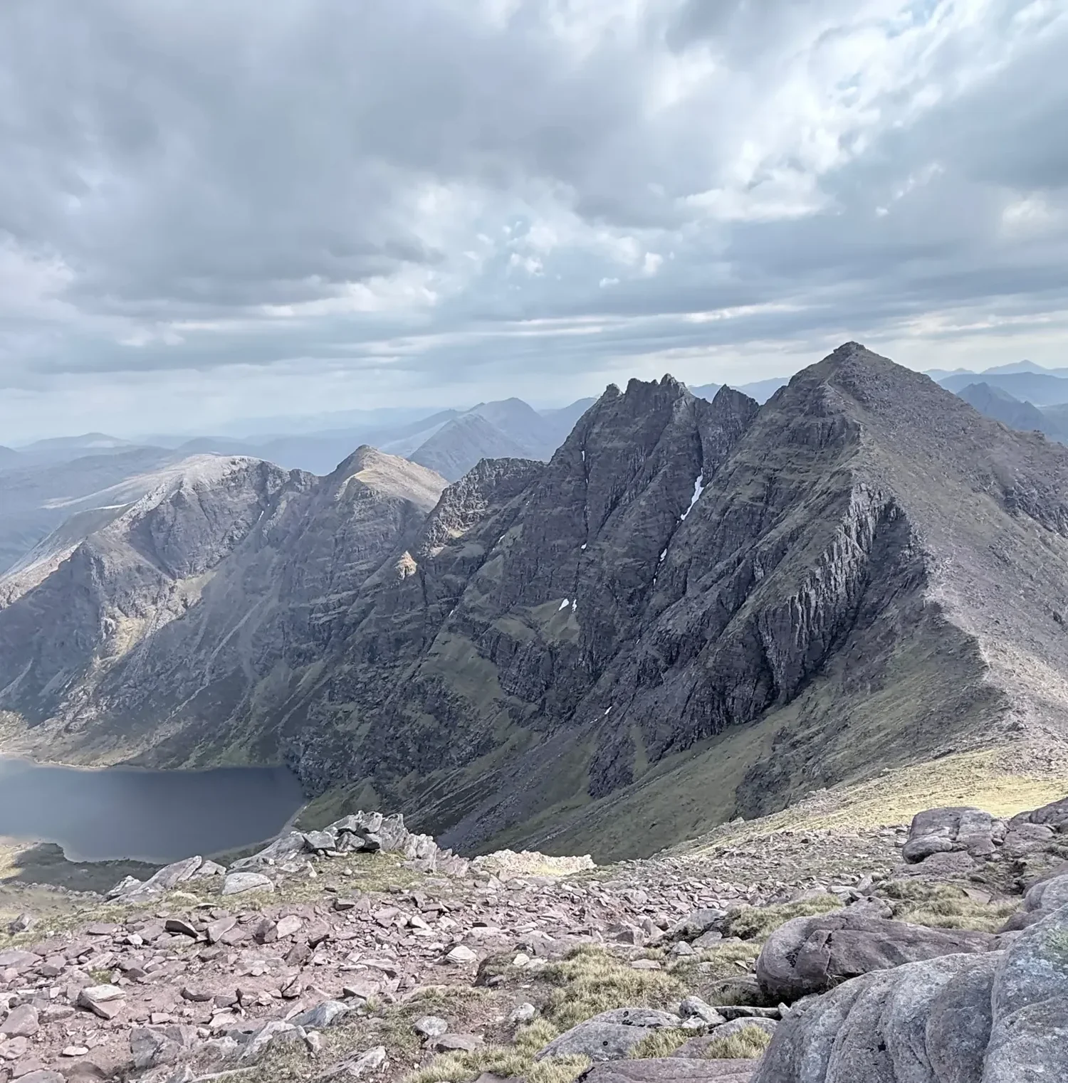 The jagged An Teallach pinnacles and Corrag Bhuidhe ridge continue through a dramatic Scottish mountain landscape.