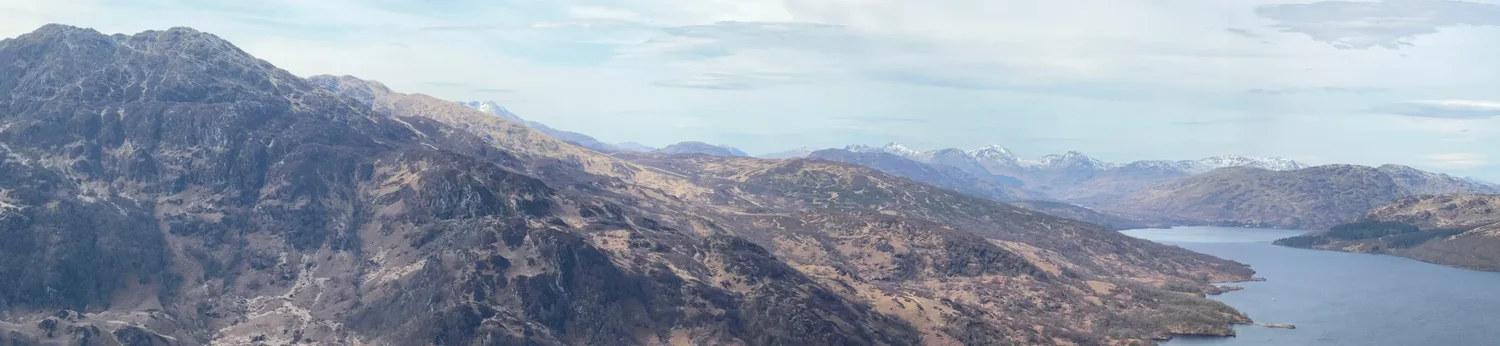 Loch Katrine stretches between the Trossachs hills, seen from Ben A’an.