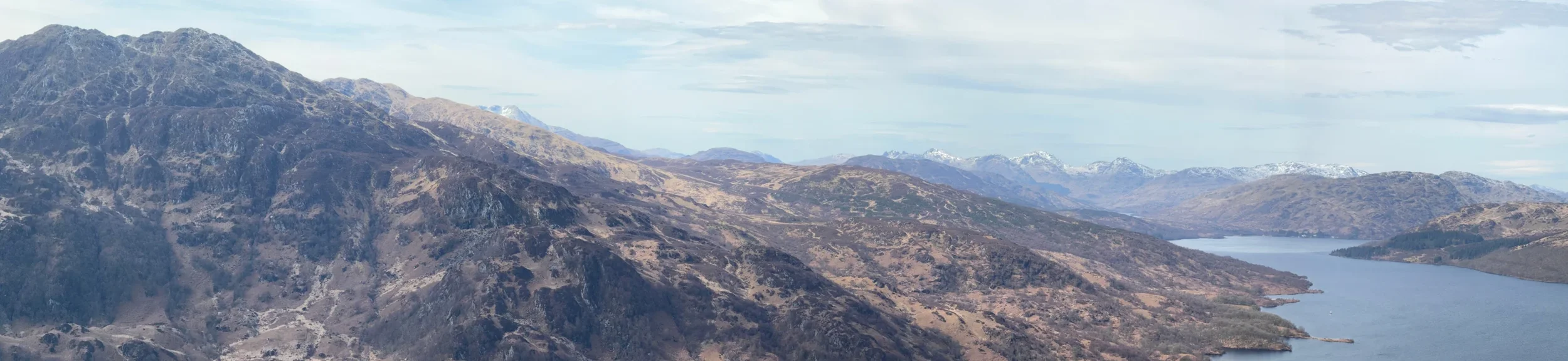 Loch Katrine stretches between the Trossachs hills, seen from Ben A’an.