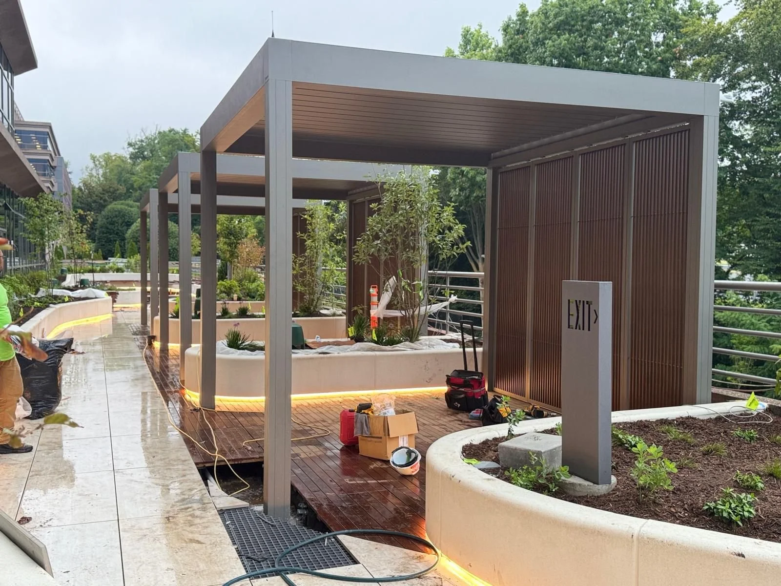 Commercial pergola installation integrated with landscaping and decking in Arlington, Virginia