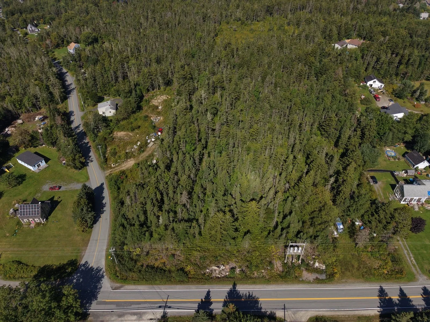 Aerial view of a wooded vacant lot with road frontage on Peggys Cove Road, Hacketts Cove, Nova Scotia