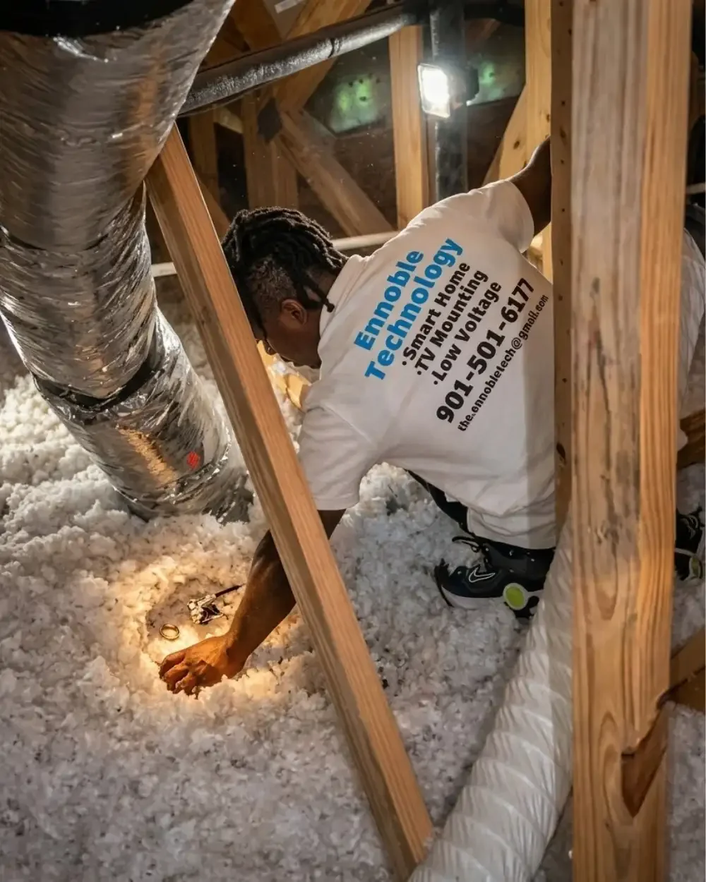 Ennoble Technician Fishing Cable in Attic Space