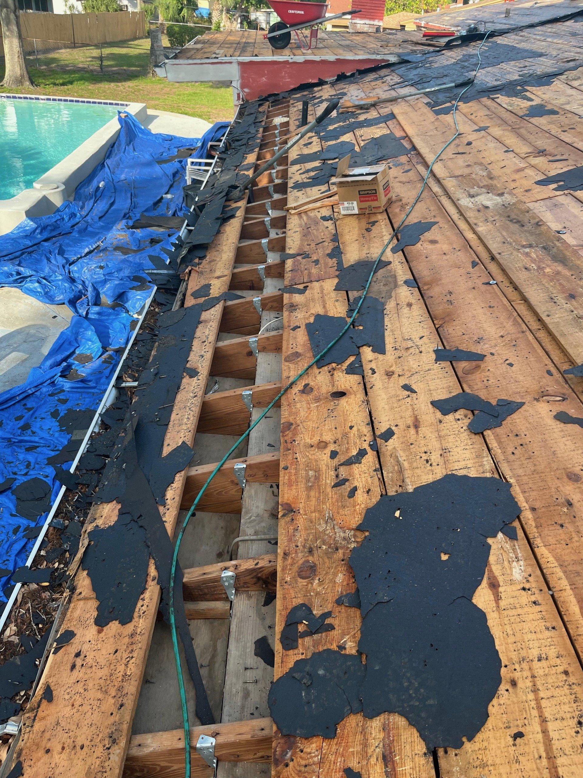 Metal hurricane storm clips securing roof trusses to the wall