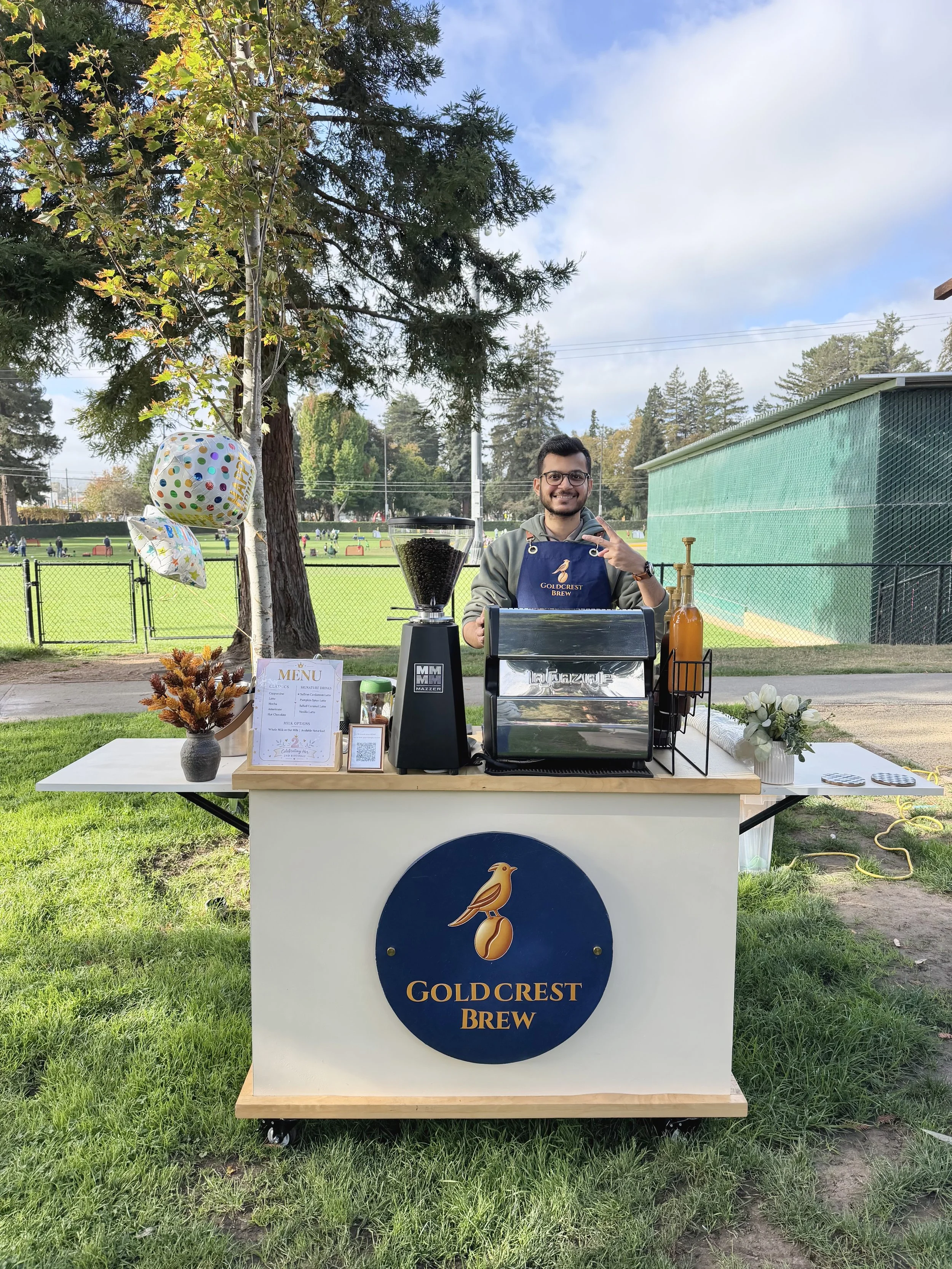 Goldcrest Brew founder Zain at the mobile coffee cart, serving guests at an outdoor celebration in the Bay Area