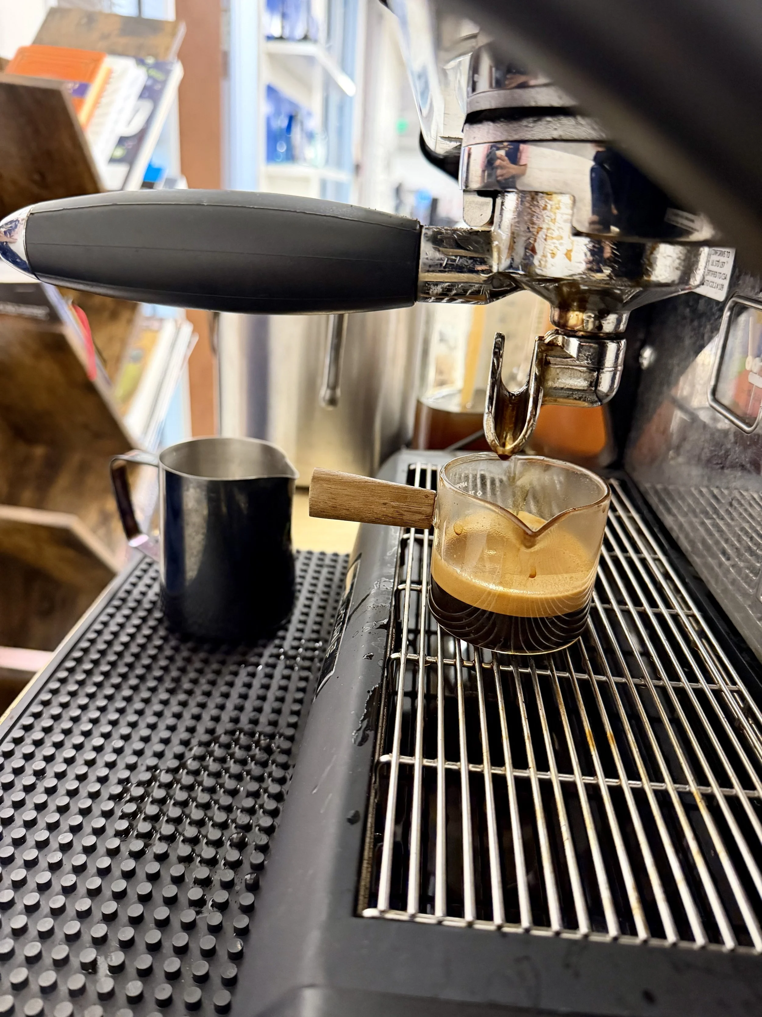 Fresh espresso shot pulling from a commercial espresso machine at a mobile espresso bar