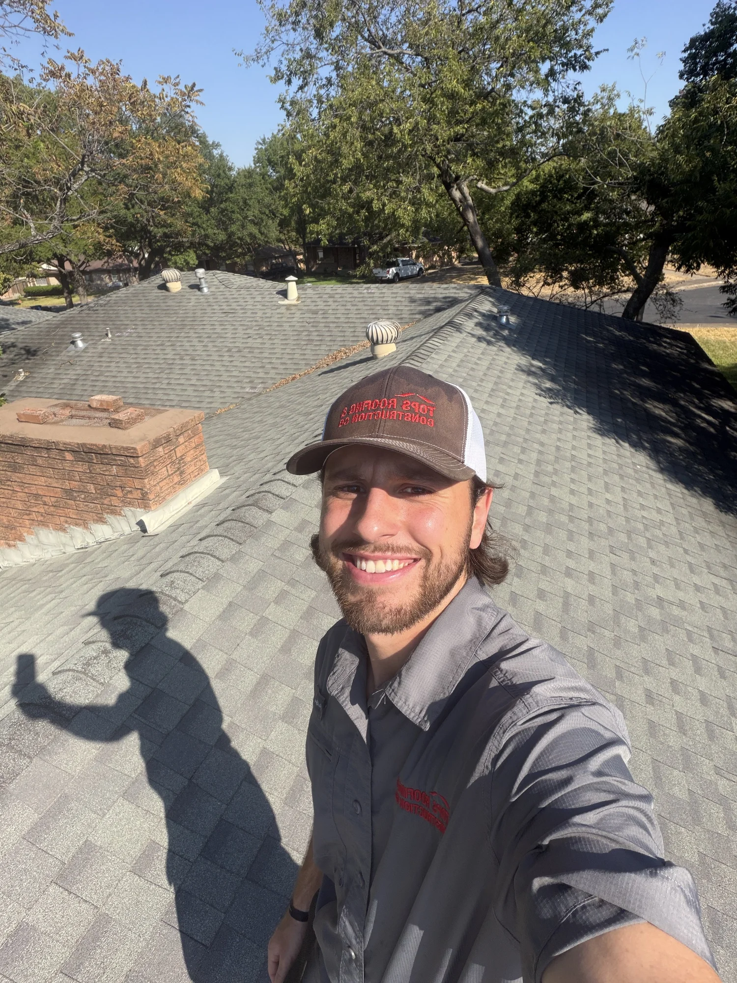 Trevor Dauzat on a residential roof in TOPS apparel