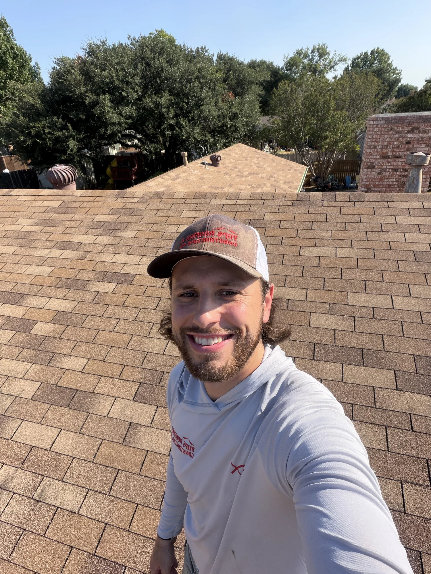 Trevor Dauzat in TOPS apparel on a shingle roof