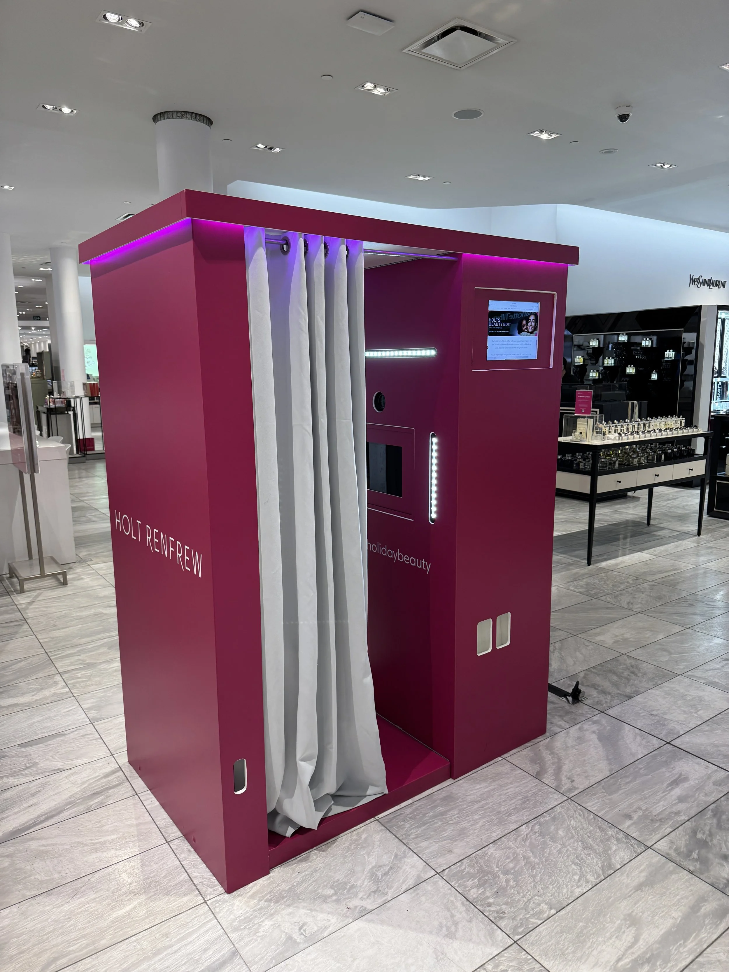 Branded enclosed photo booth setup in a retail space