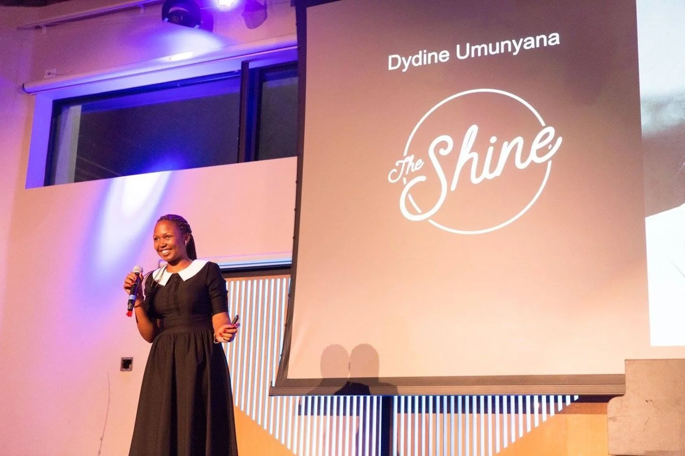 Dydine speaking to an audience