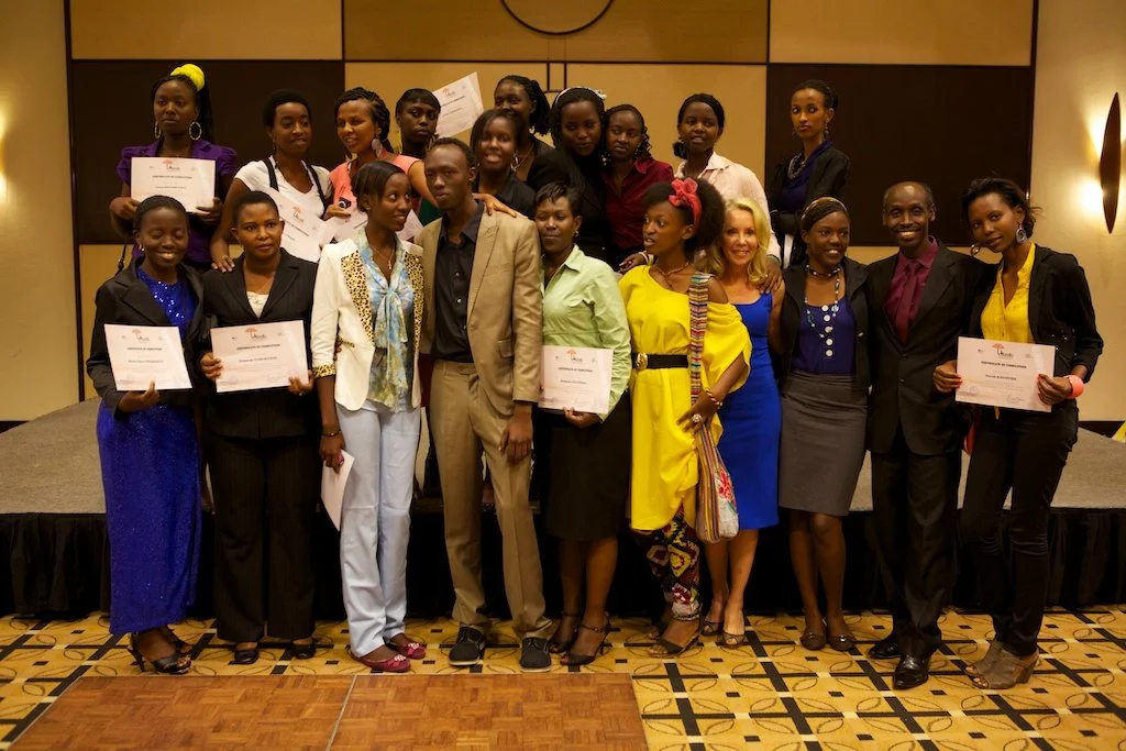 Graduates of the Women's Potential in Cinema workshop on stage with their certificates of completion, alongside international partners, at the closing ceremony — Kigali Serena Hotel, March 24, 2013.