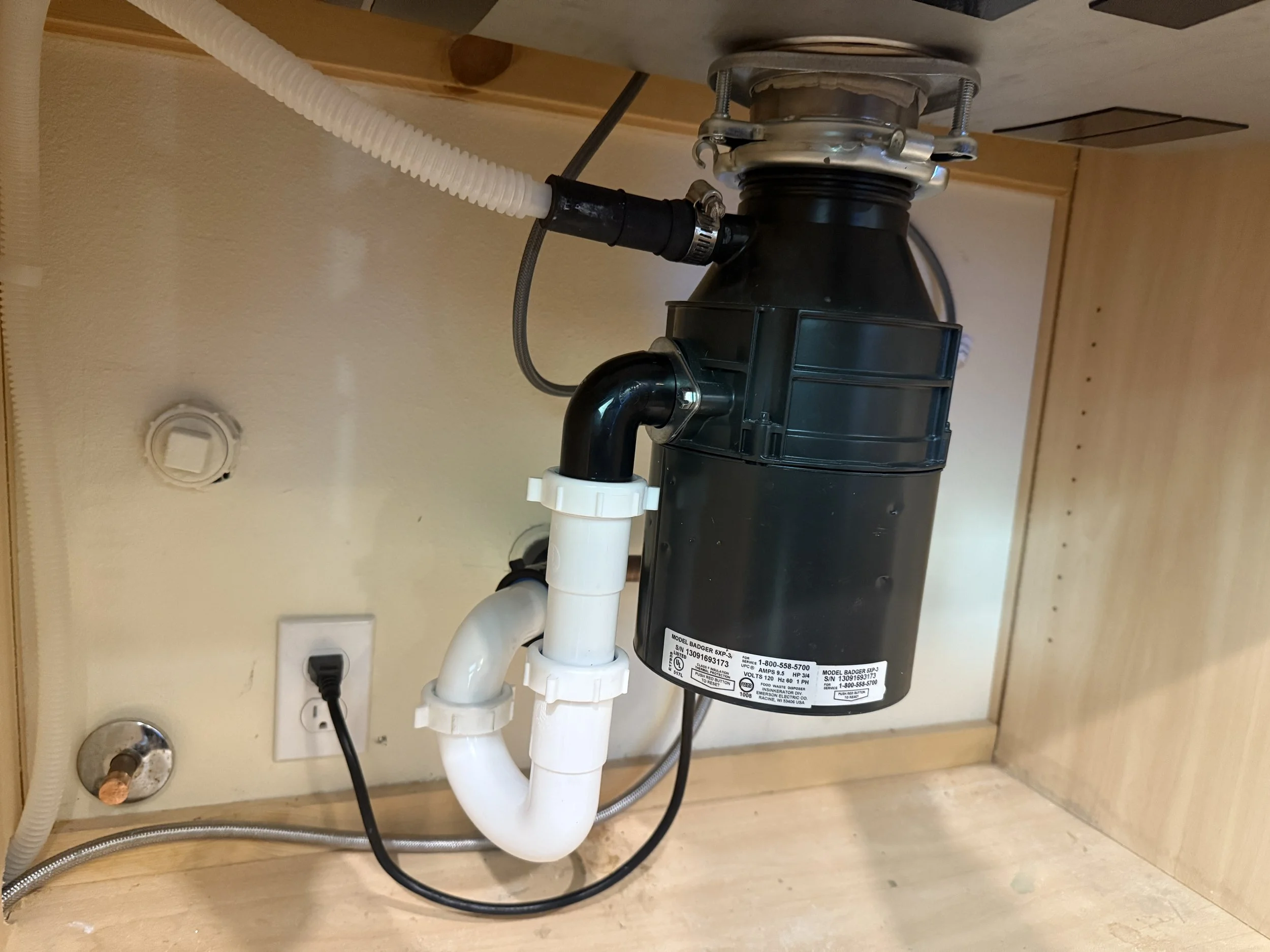 New garbage disposal replacement in Duvall, WA by Neptune Plumbing, restoring kitchen sink drain function after a broken disposal unit stopped working.